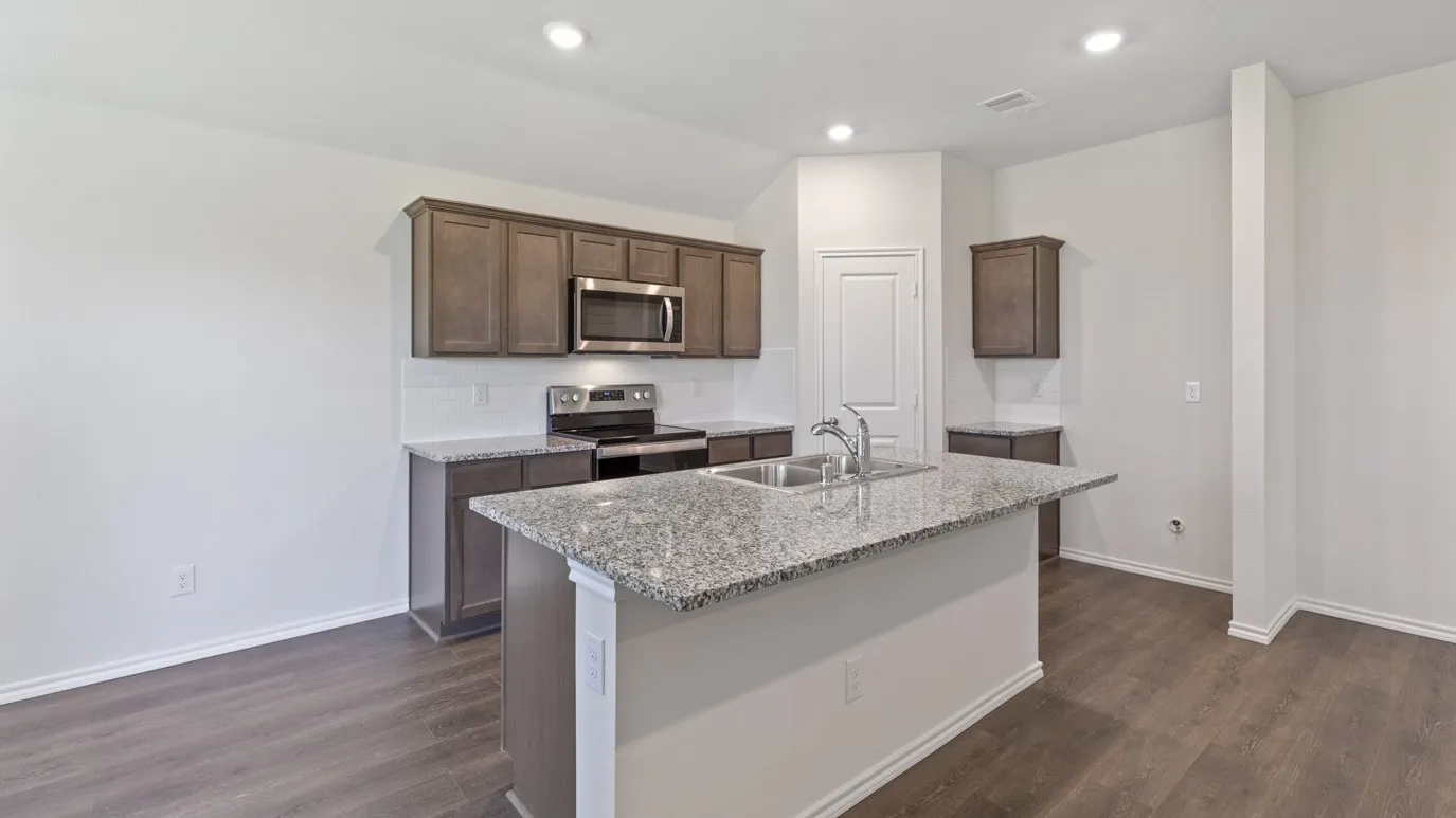 Kitchen featuring an island with double basin sink, stone countertops, wood-finish flooring, recessed lighting, and stainless steel appliances