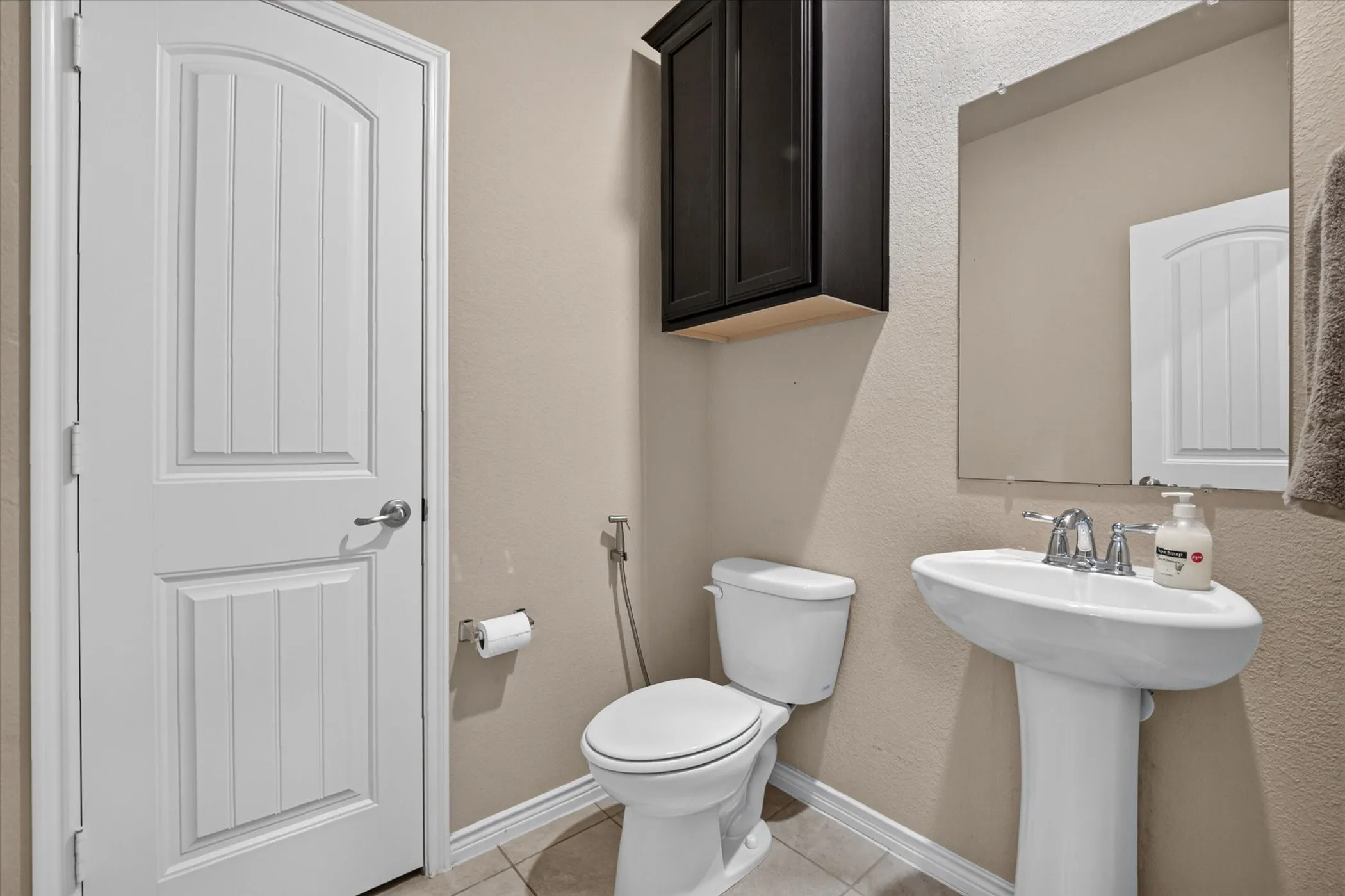 Pedestal sink with chrome faucet and rectangular mirror