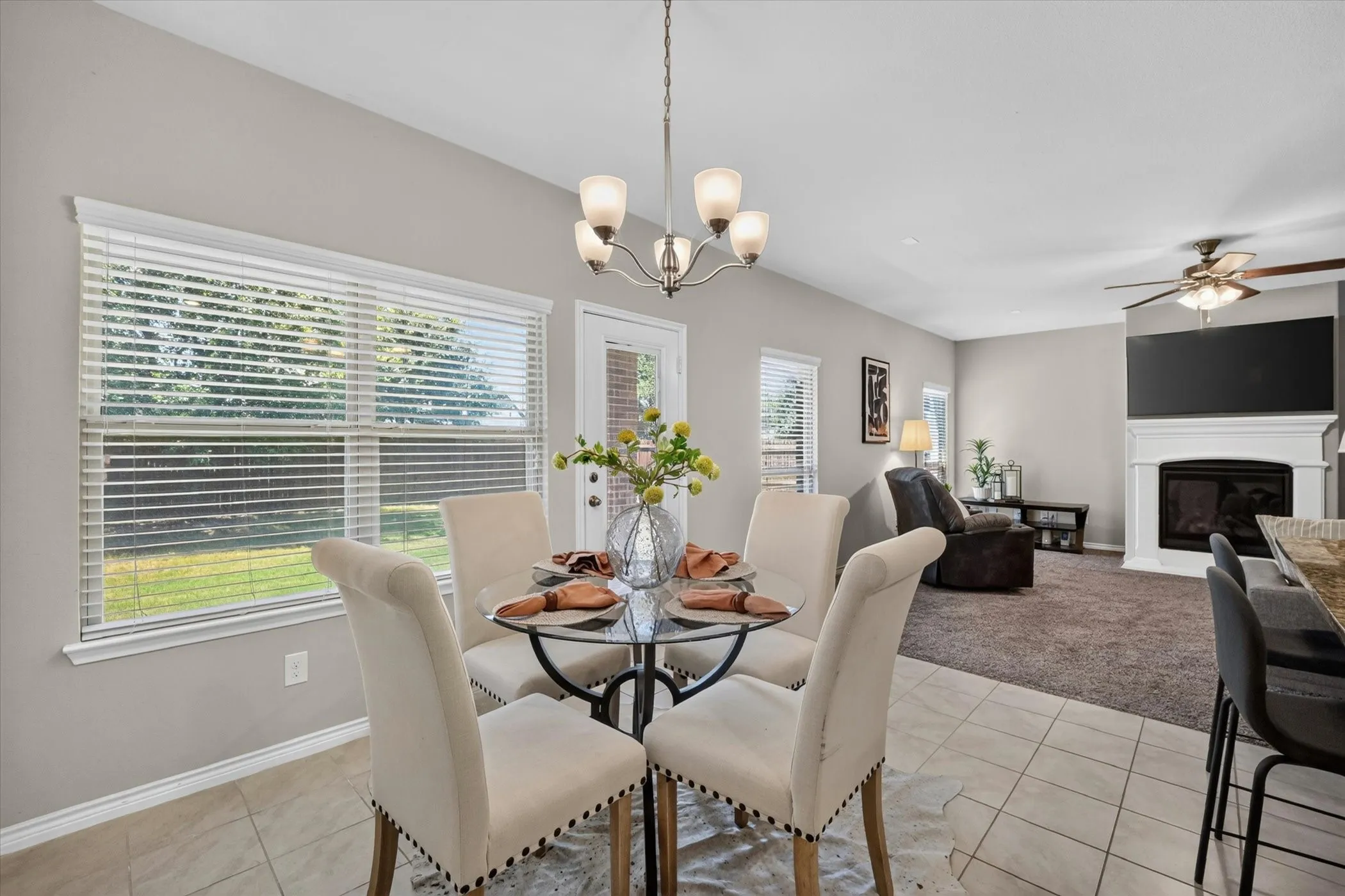 Dining area with tile flooring and a multi-light chandelier
