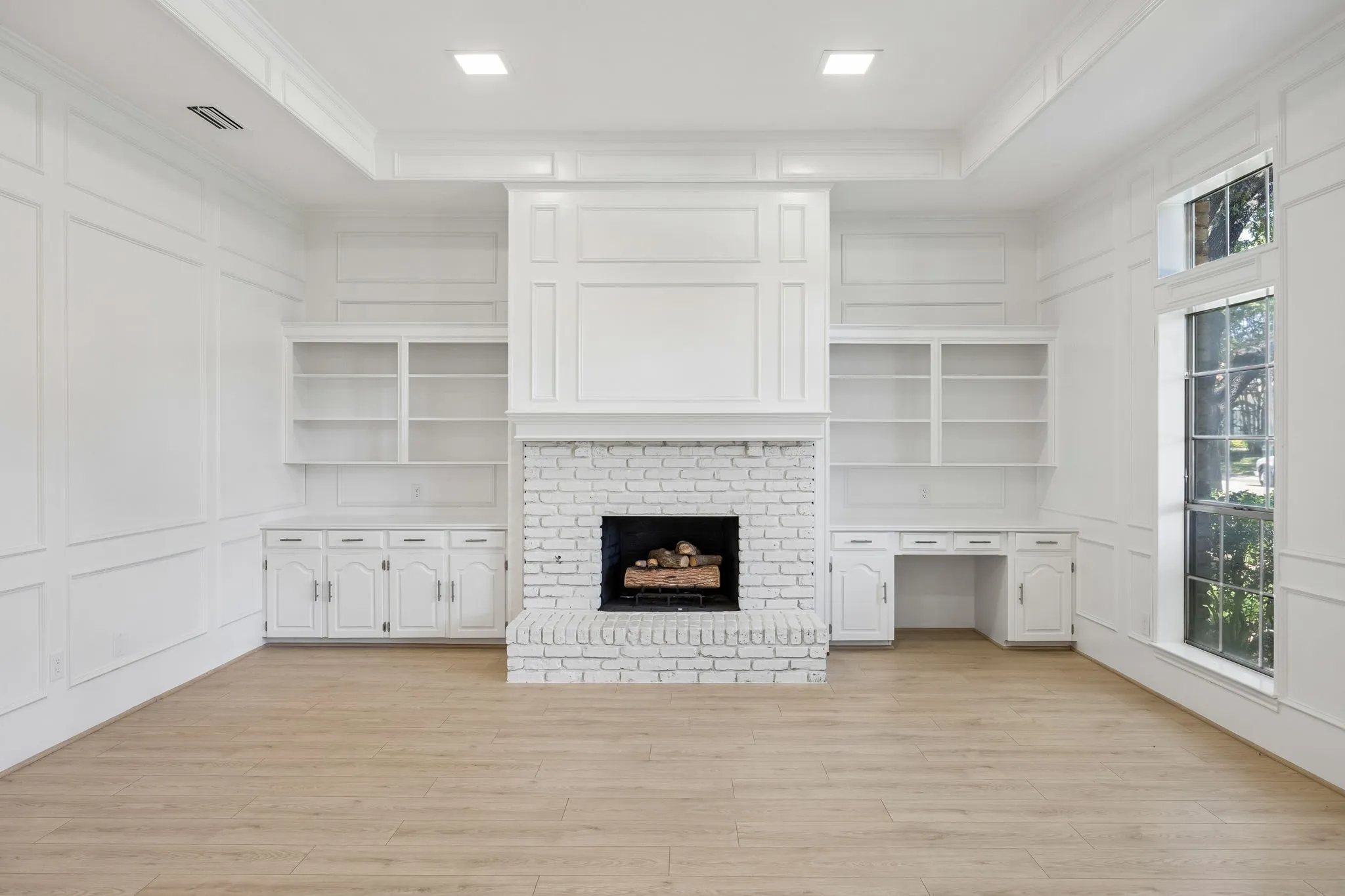 Wood burning fireplace with built in book shelves and desk