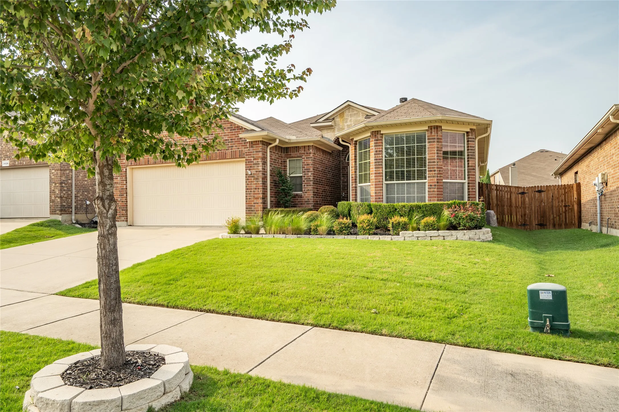 View of front of house with a garage and a front yard