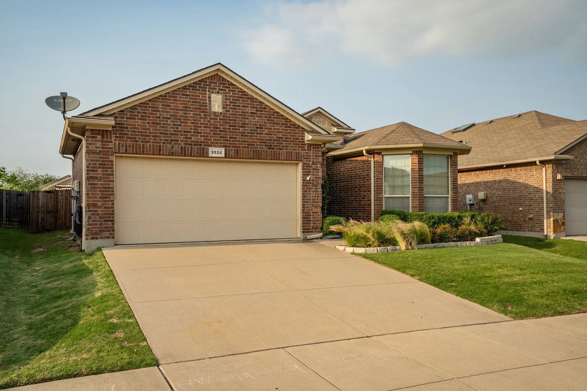 View of front facade with a garage and a front lawn