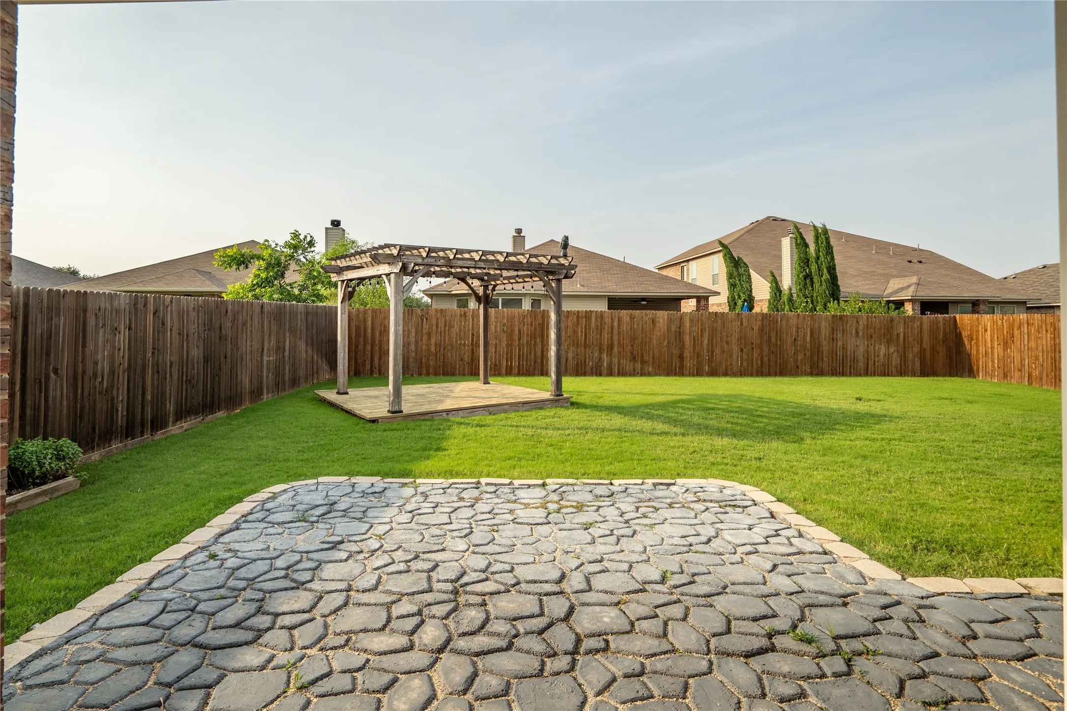 View of yard featuring a patio area and a pergola