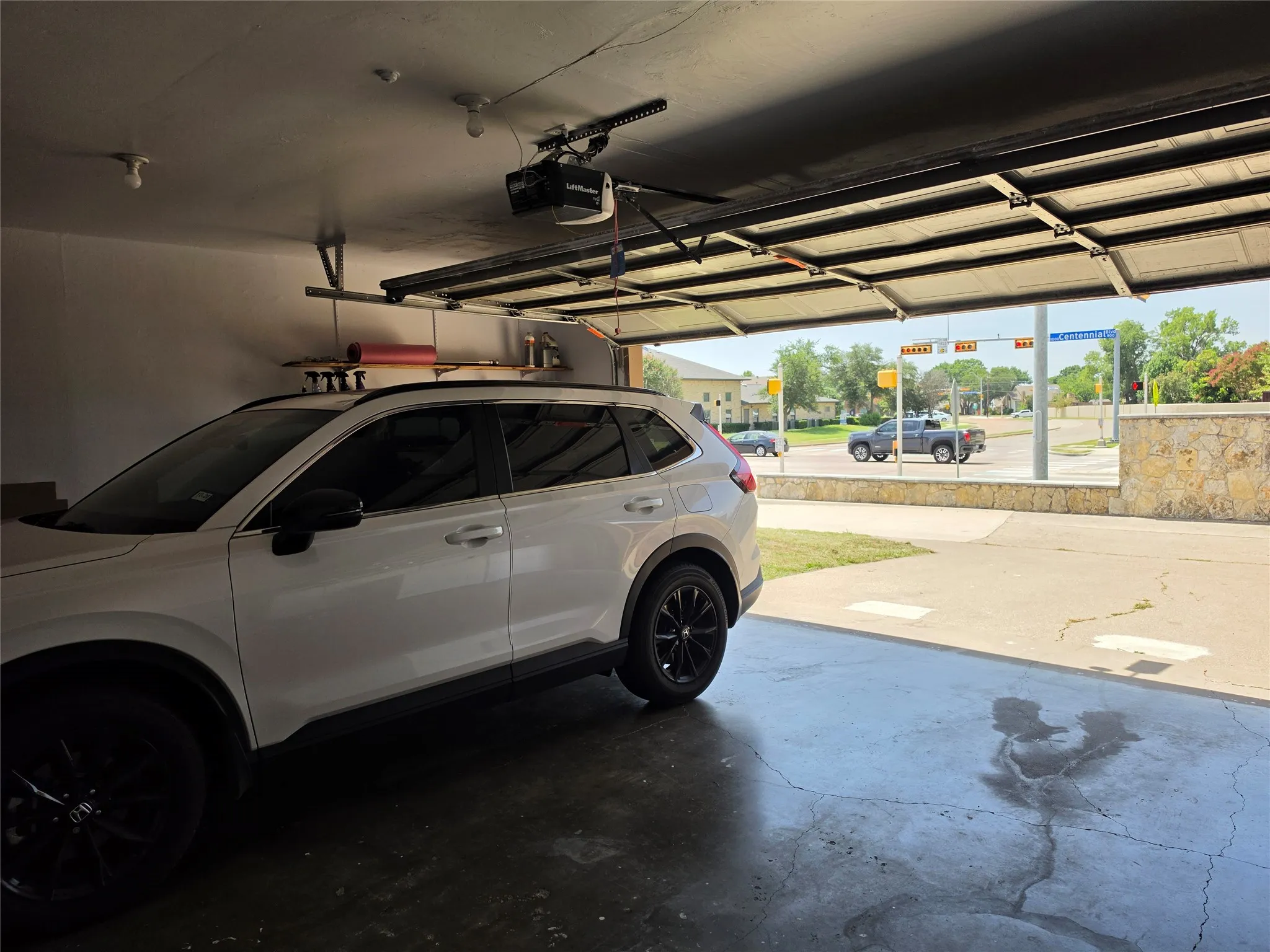 Single-car garage with an automatic overhead door and a concrete floor