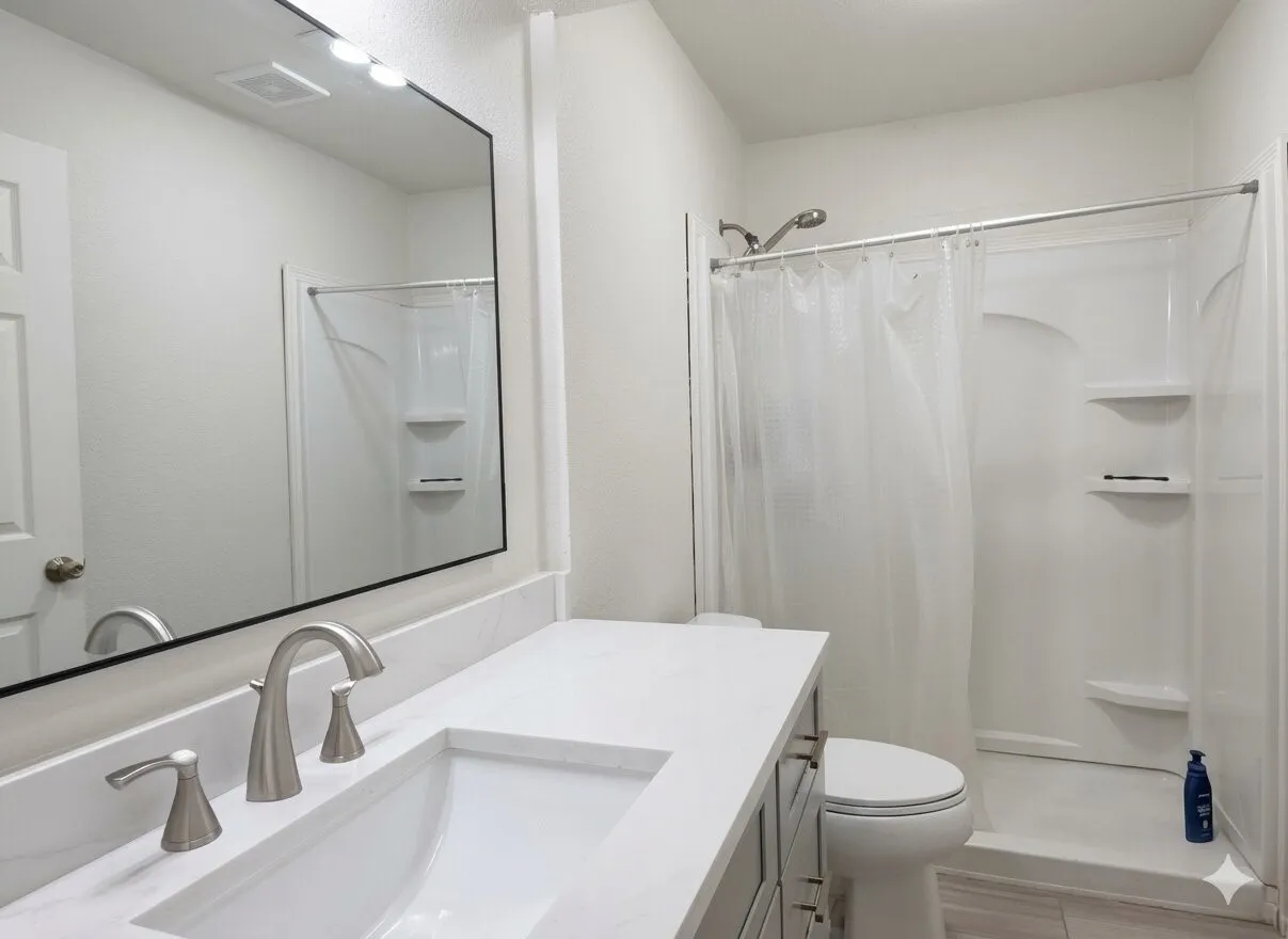 Bathroom featuring a vanity with an integrated sink, brushed nickel faucet, and a large mirror with overhead lighting