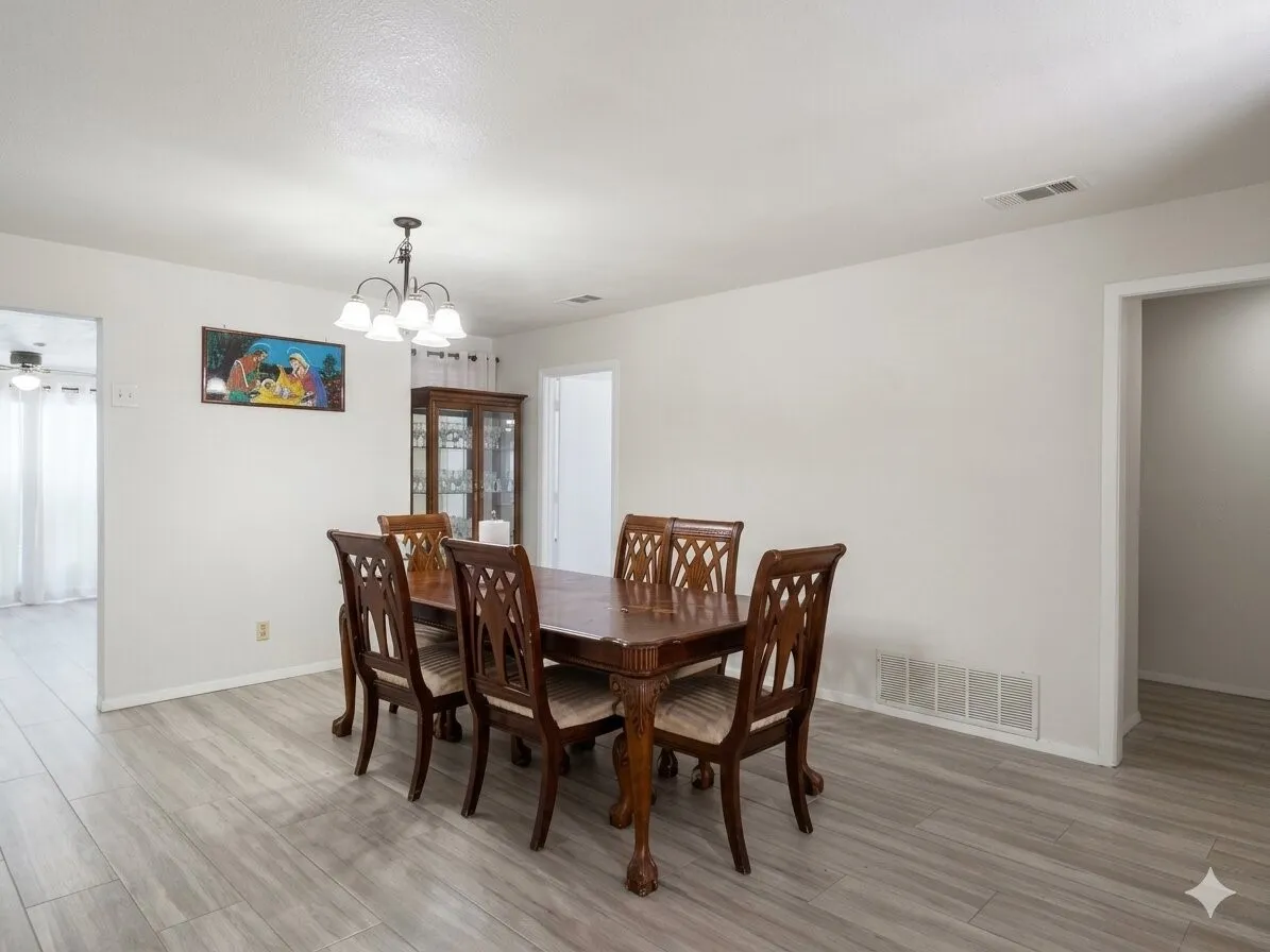 Dining area featuring light wood-finish flooring and a ceiling-mounted light fixture