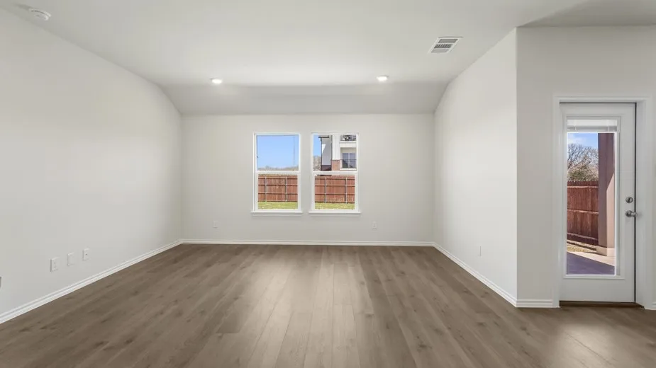 Spacious interior with wood-finish flooring, recessed lighting, and white baseboards