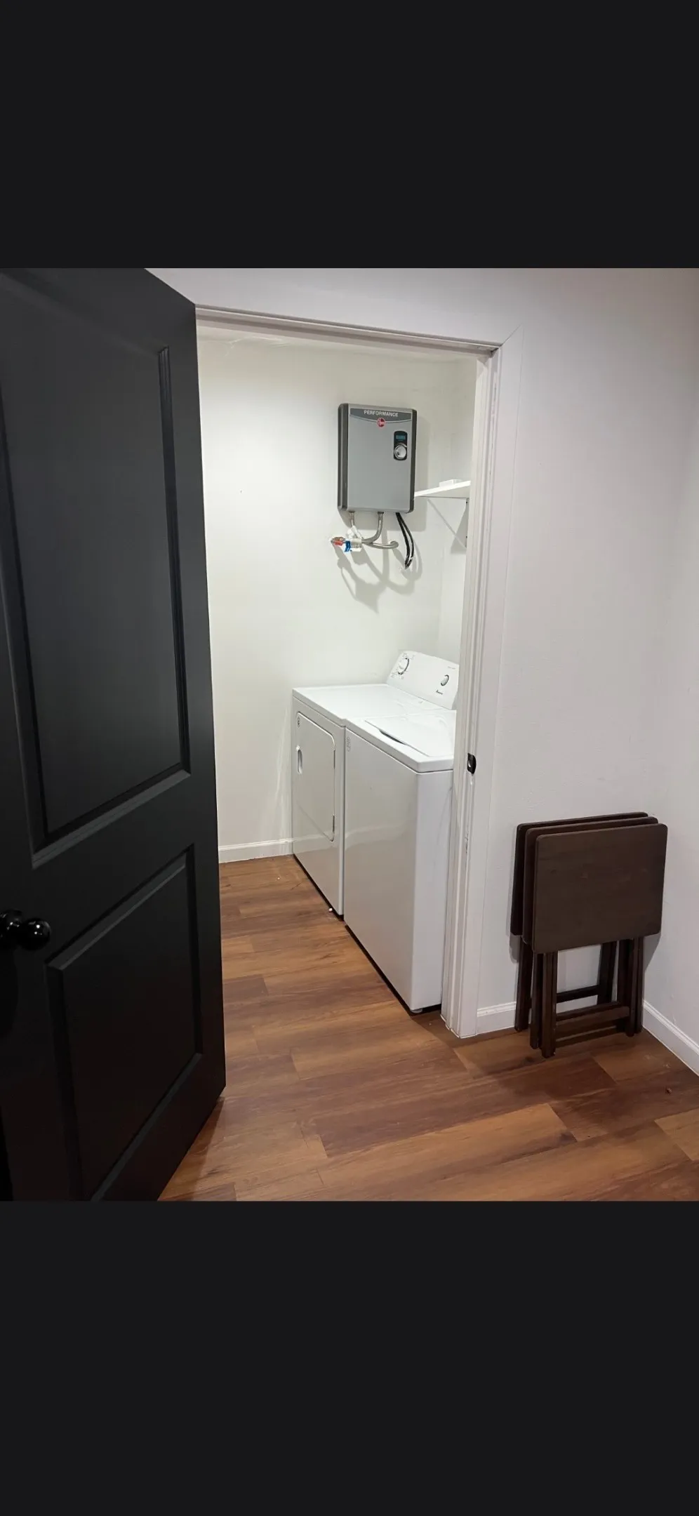 Dedicated laundry area featuring wood-finish flooring