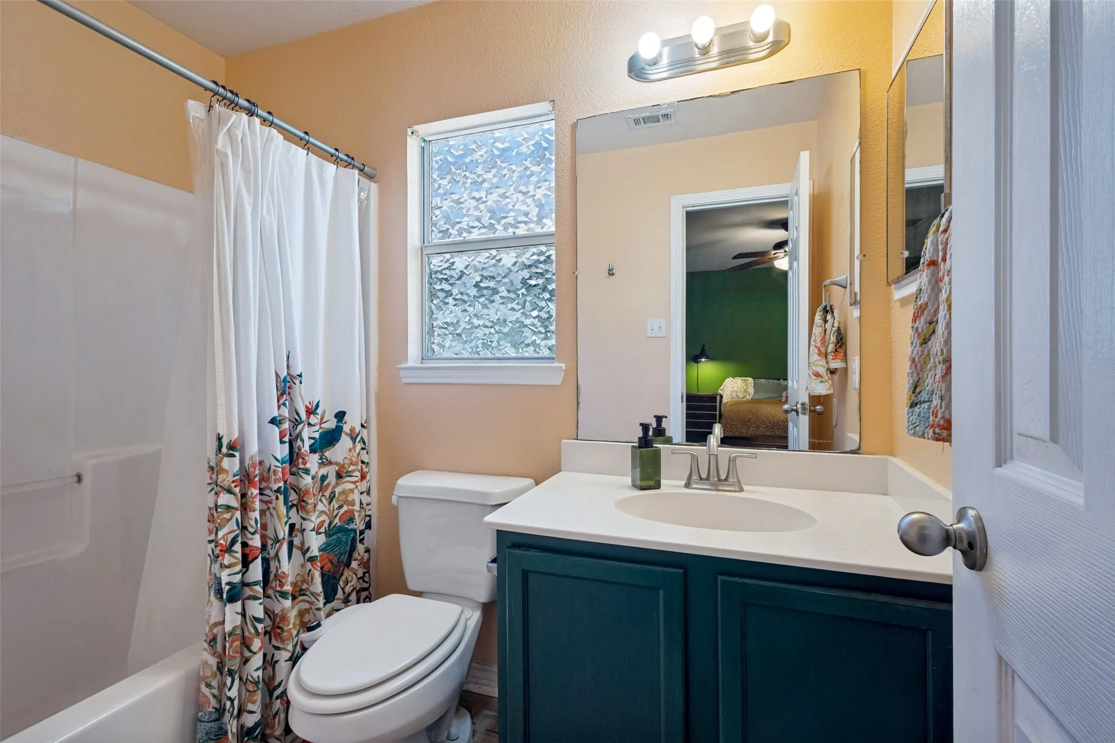 The primary bathroom features an inviting color palette, a window, mirrored medicine cabinet and an unexpected luxury item--a bidet!