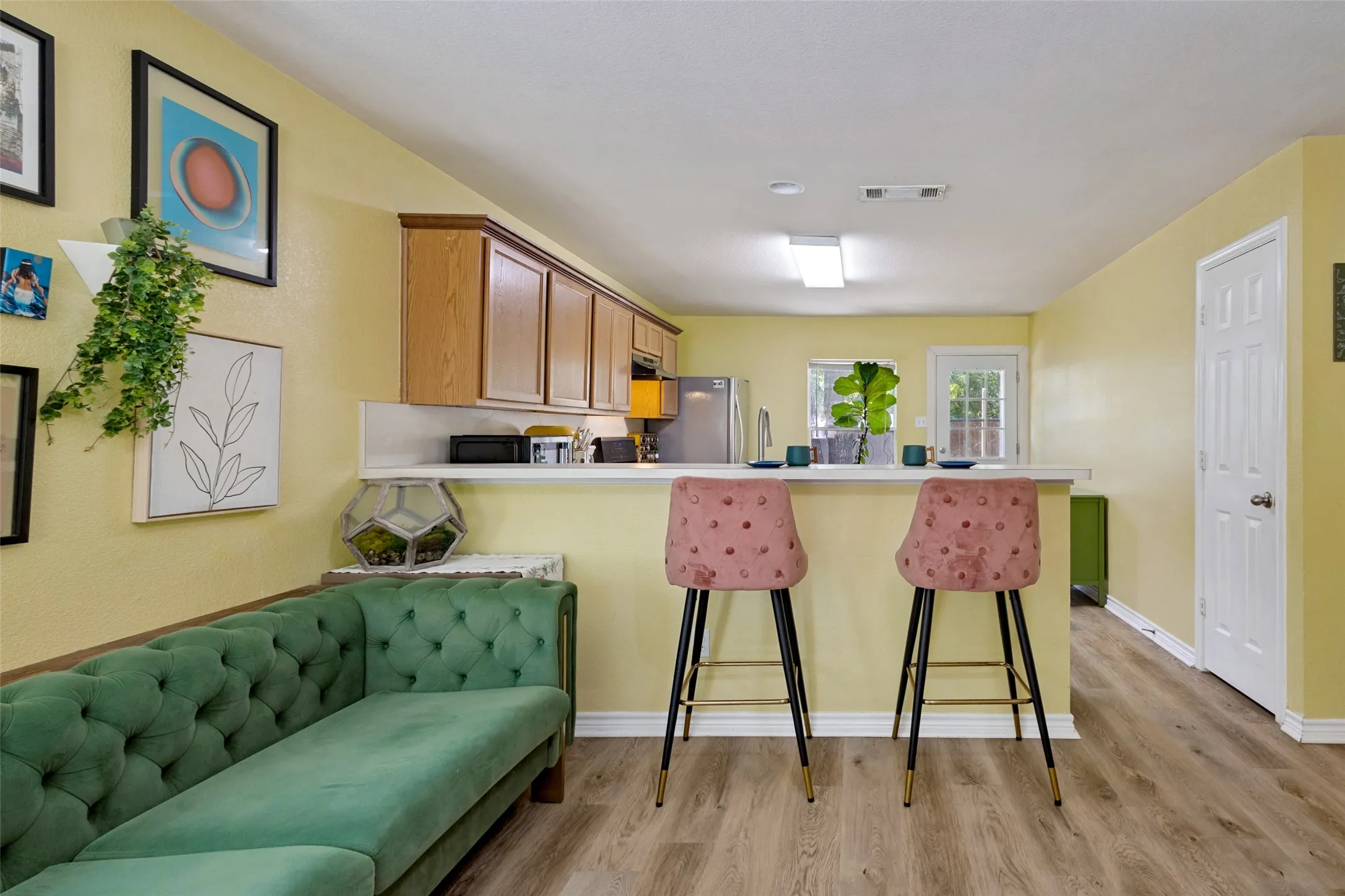 The kitchen features an eating bar, pantry (door to the right) and access to the backyard.