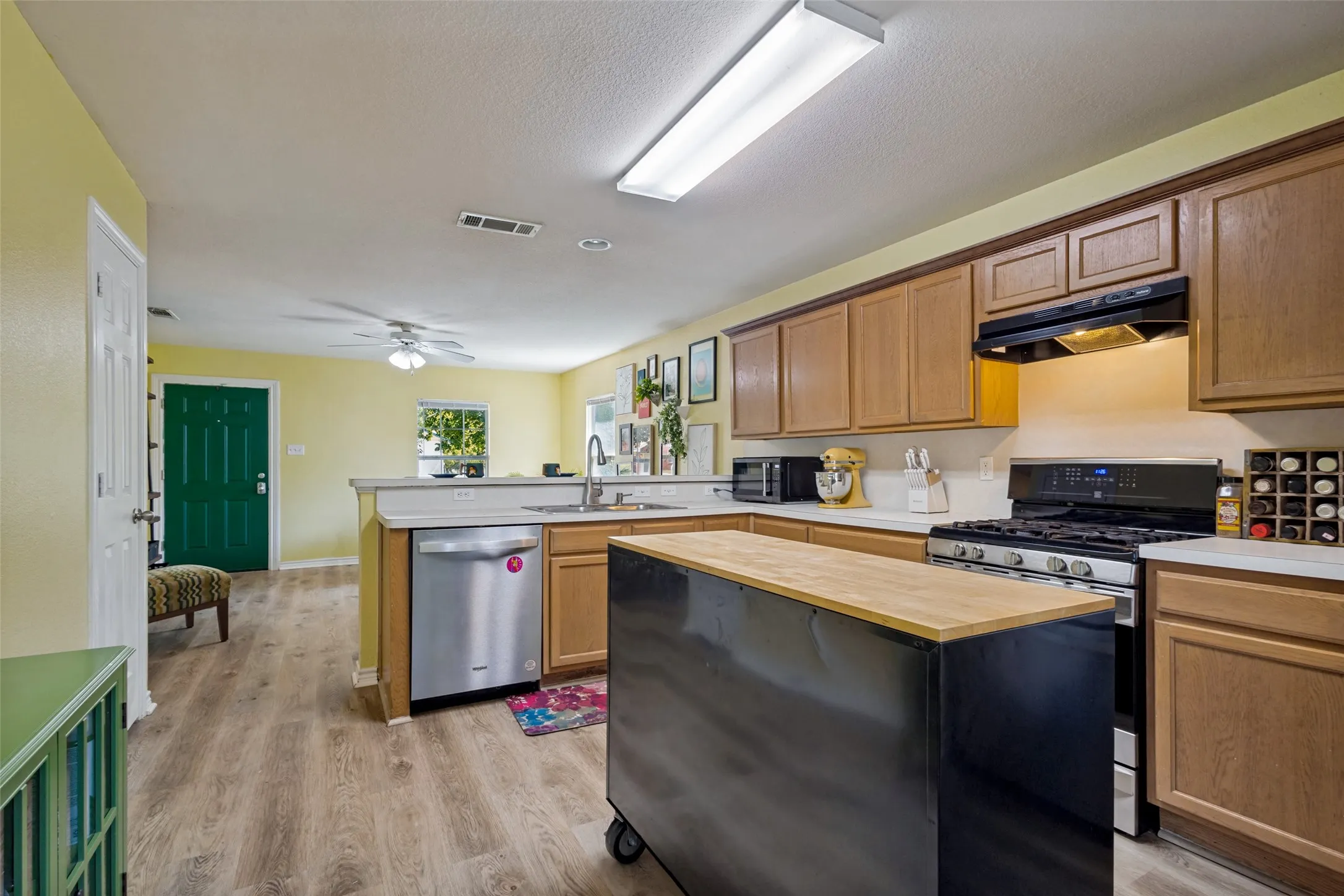 View from the back door.  The layout of the kitchen keeps you connected to the living room, making it easy to prepare meals, visit with family, and stay part of the conversation without feeling separated from everyone else.