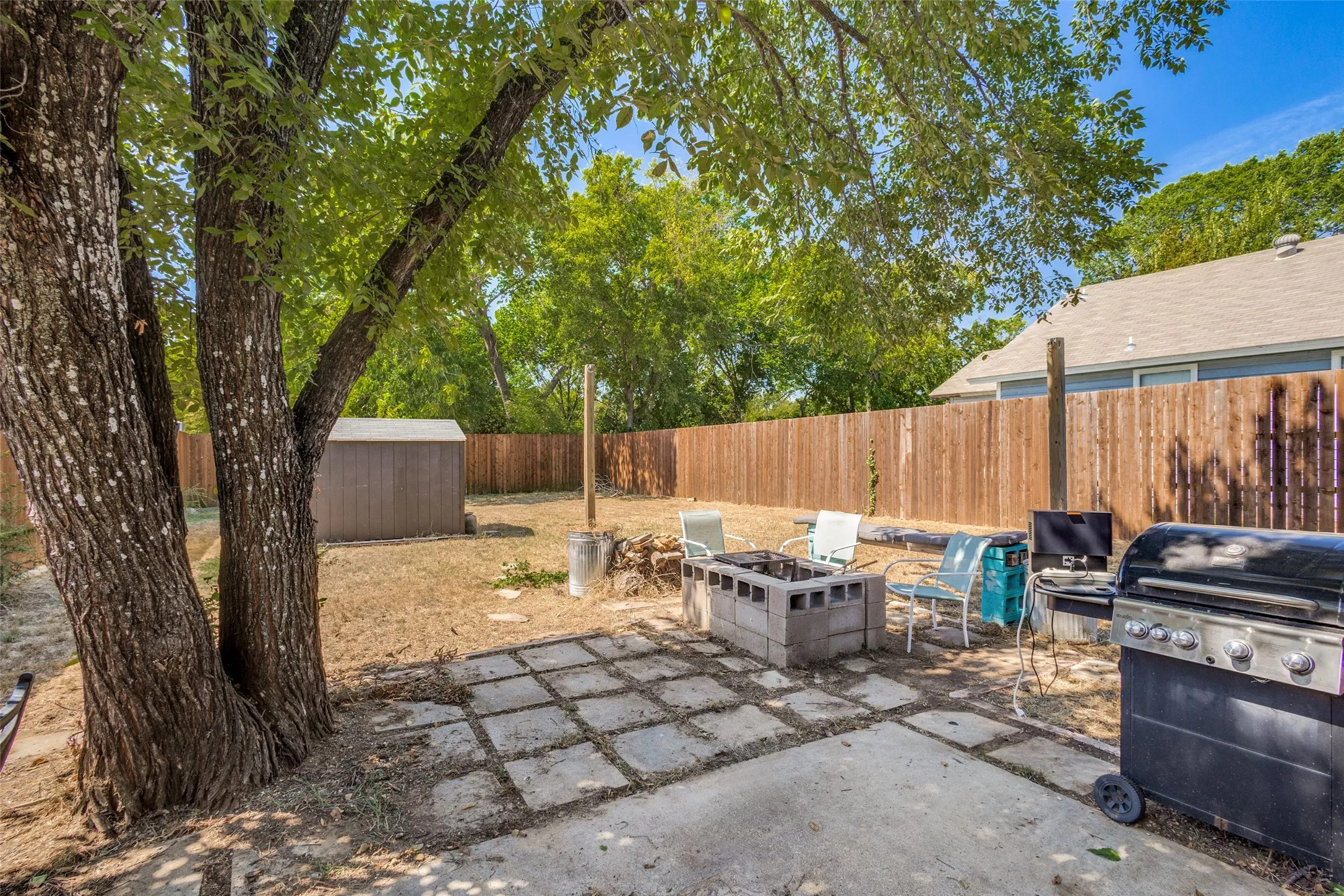 The extended back patio has plenty of space for outdoor entertaining.  There is even a firepit off to the side that can be used for cooking or just taking the chill off on a cool evening.
