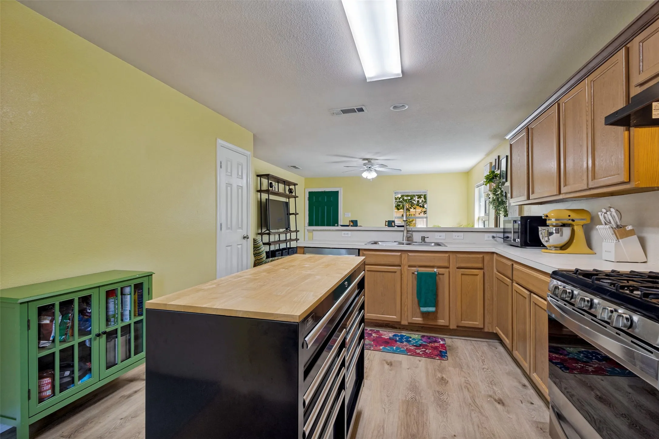 The open kitchen has plenty of space for a piece of furniture to display and store items like dishes, cookbooks and knickknacks.