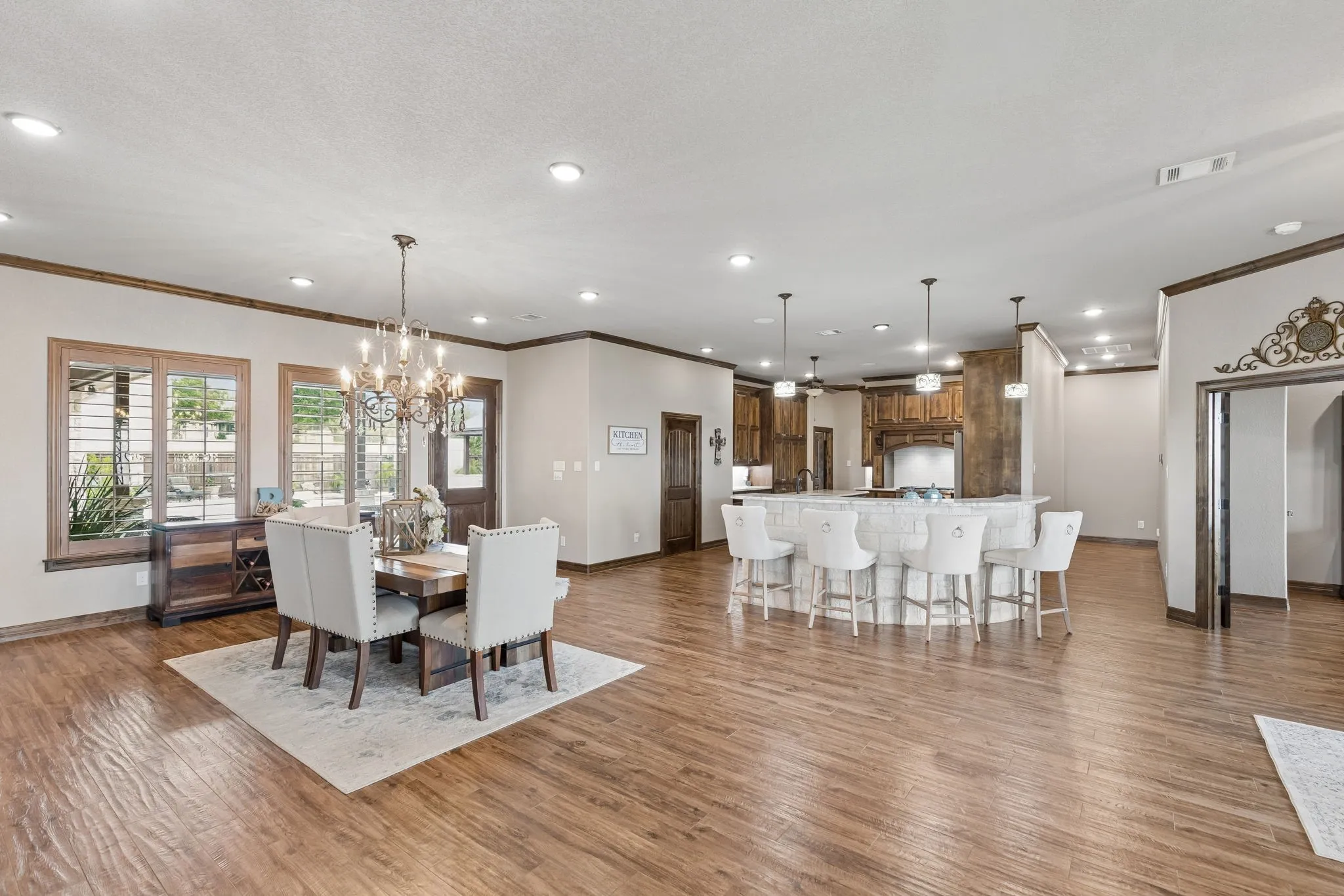 View looking toward the kitchen from the living area. The dining area has a beautiful view of the pool area. Pick your view of the pool or the lake as you dine in this elegant room.