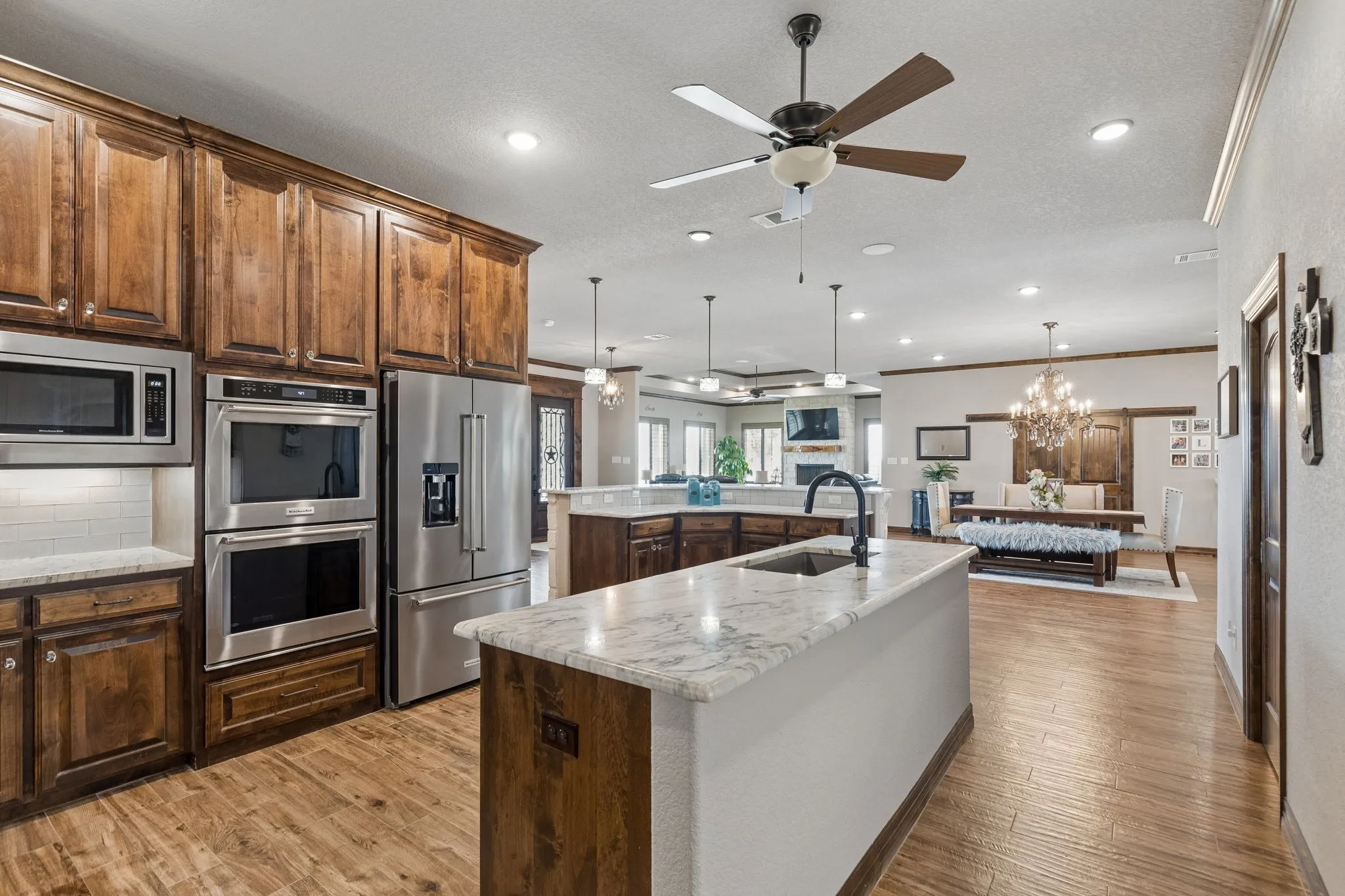 Truly a chef's dream kitchen with an oversized island, double ovens, huge walk-in pantry and abundant wood custom cabinetry.