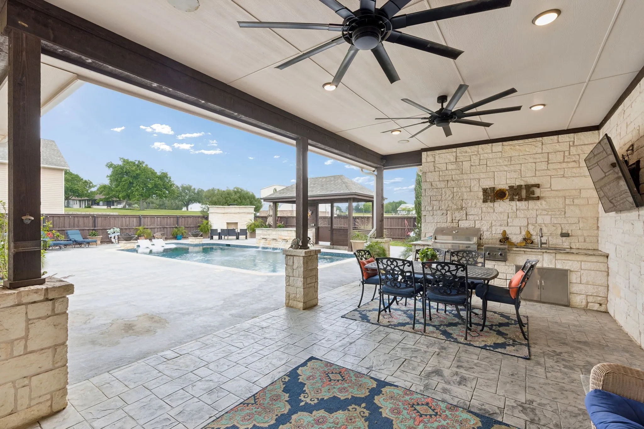 Lovely covered outdoor space for outdoor dining and entertainment. Grilling convenience and comfort. Surround sound and a door with easy access to a half bath for your guests.