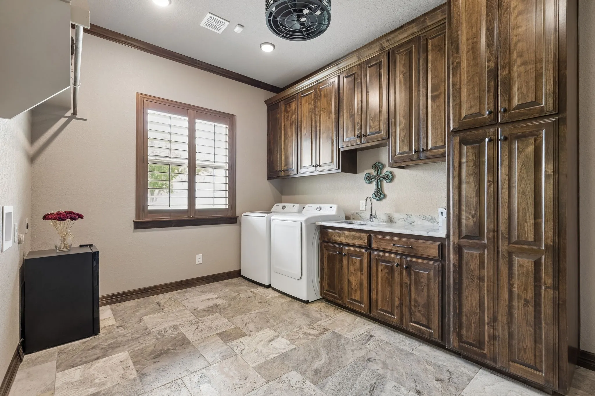 Oversized laundry room with hookups for two sets of washers and dryers. There is also a mudroom-style bench in this room along with a door adjoining this room to the primary master closet. Super convenient.