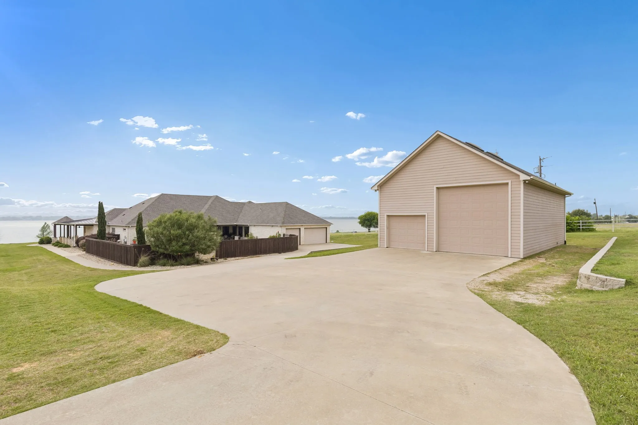 The RV barn has two garages, one has a 14' door and the other is a standard 10' for your RV, extra vehicles, boats or trailers. The home has 3 garage parking spaces. Also so note the private concrete pathway from the rear of the home to the front entrance in this photo.