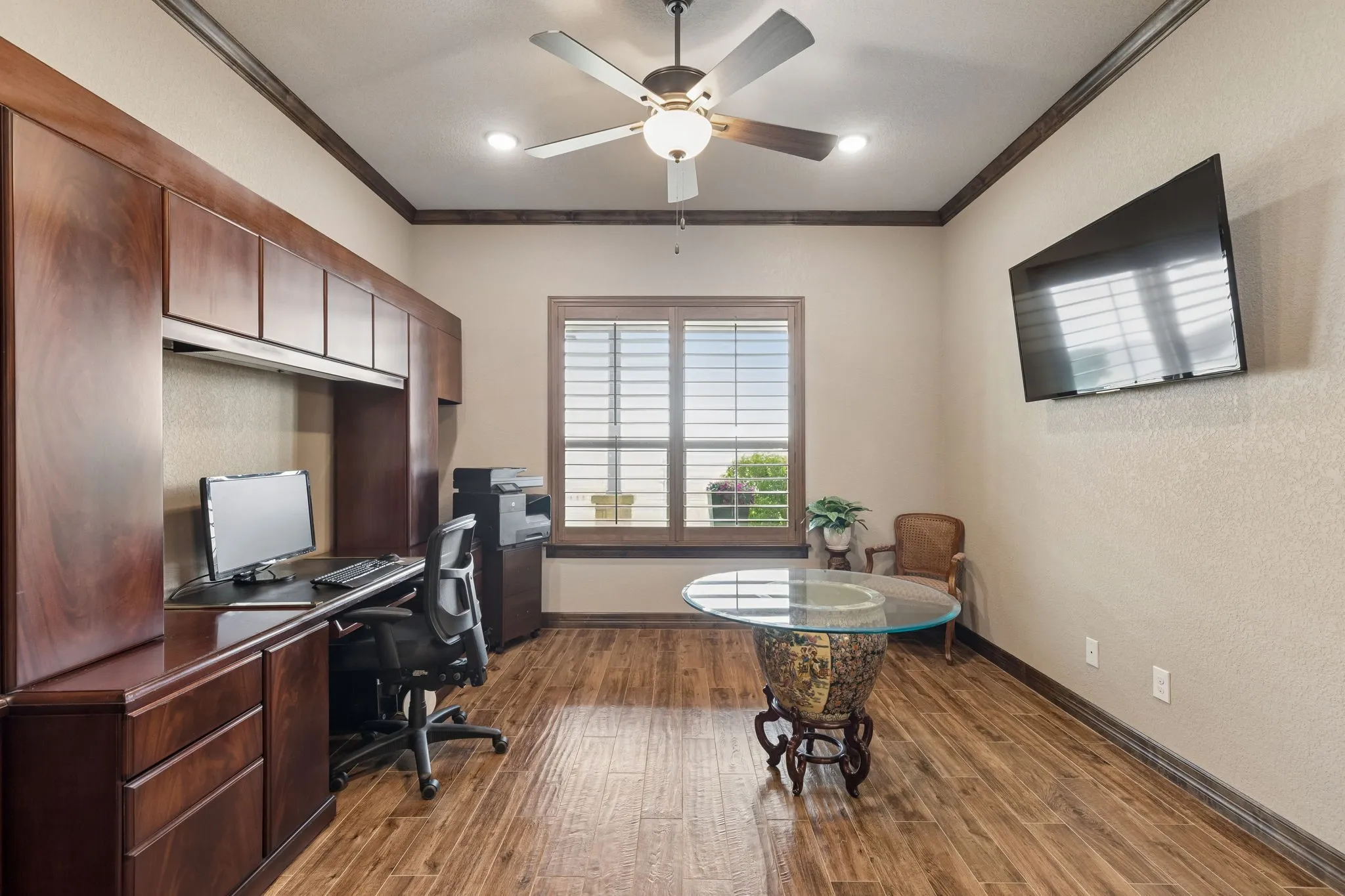 Beautiful view of the lake in this home office which also has a full closet, allowing it to be used as a fourth bedroom if desired. All televisions convey with the home purchase. Elegant french doors open from the foyer into this space.