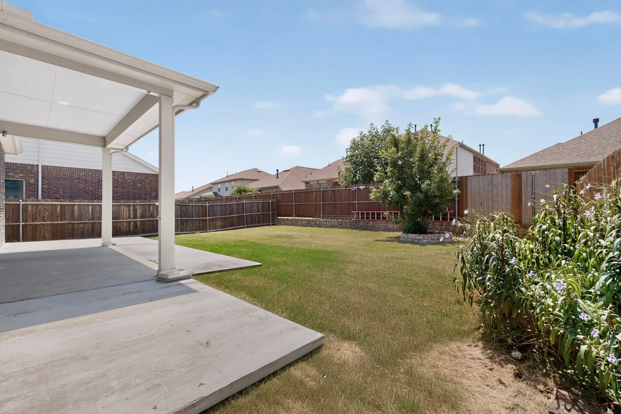 Expansive concrete patio with a covered outdoor area