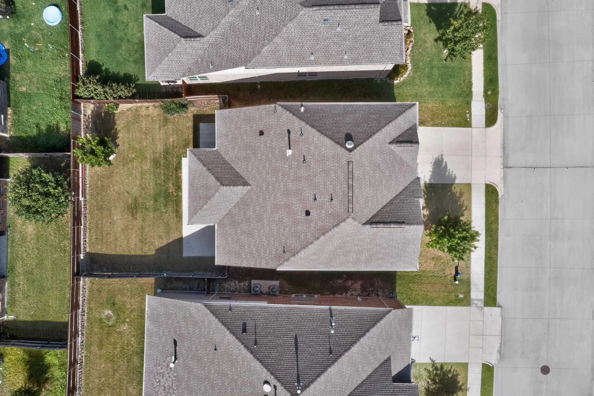 Aerial perspective showcasing a residential property with a gray asphalt shingle roof