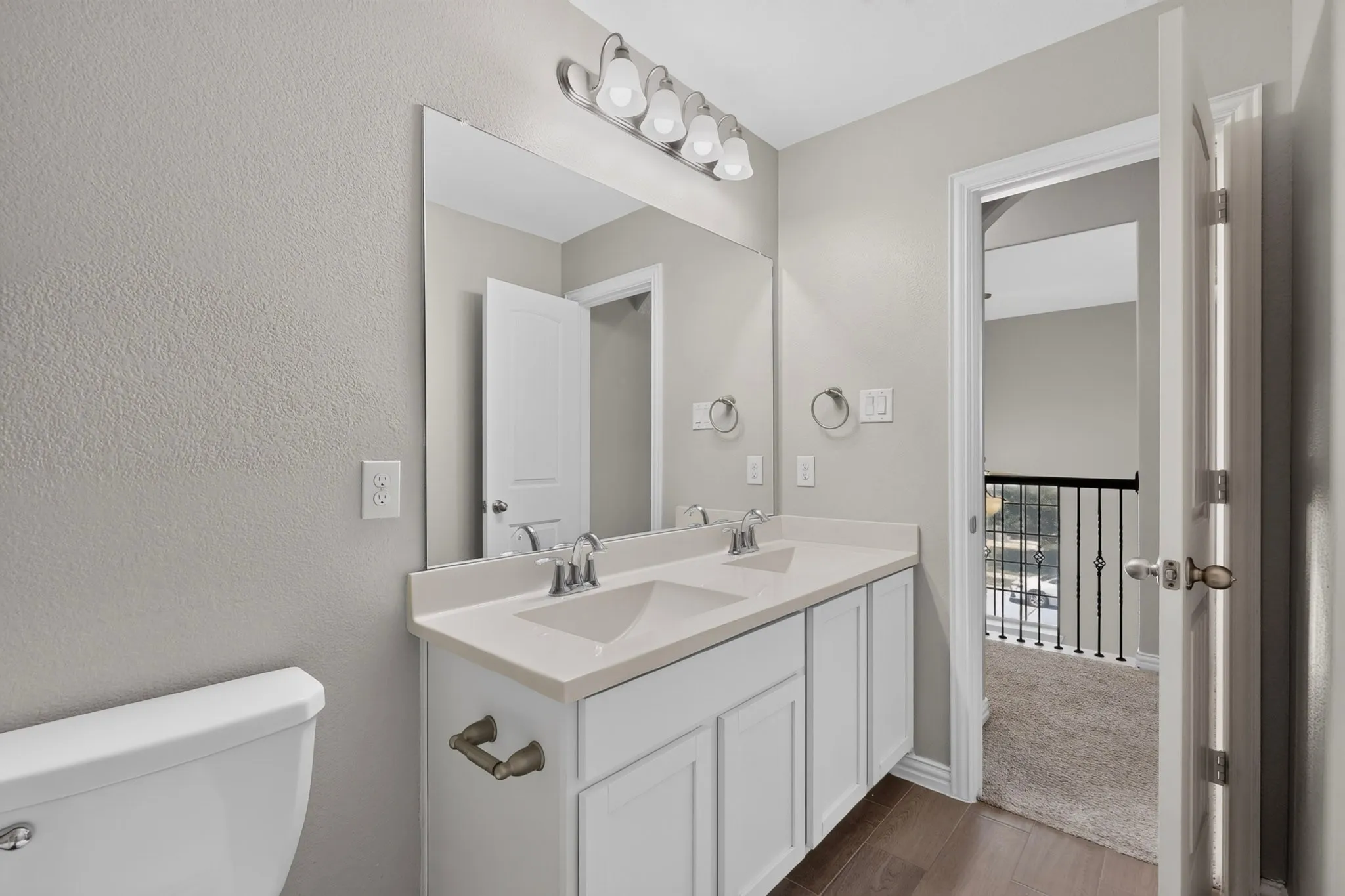 Dual vanity with white cabinetry, light-toned countertop, and undermount sinks