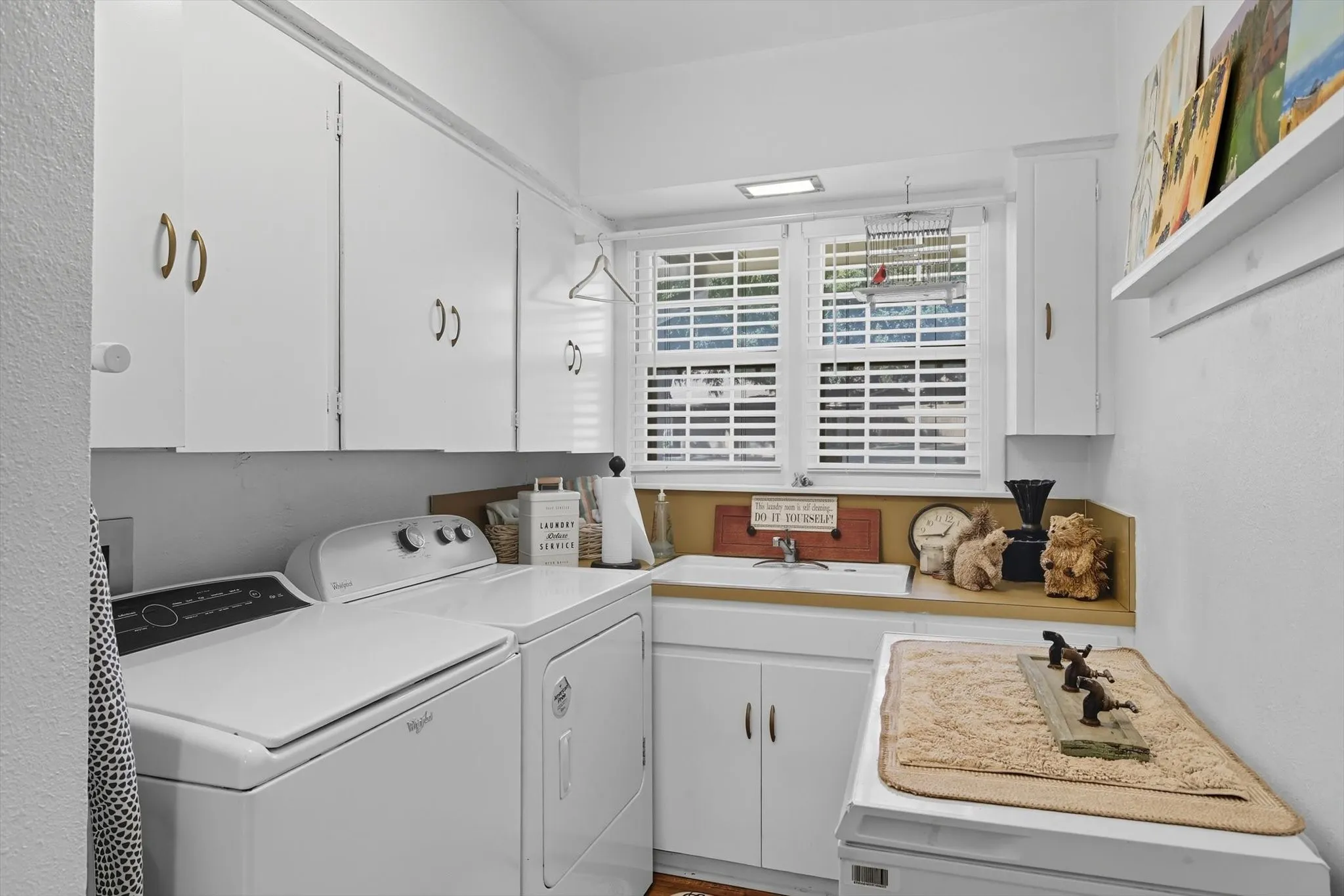 Washroom featuring cabinet space and separate washer and dryer