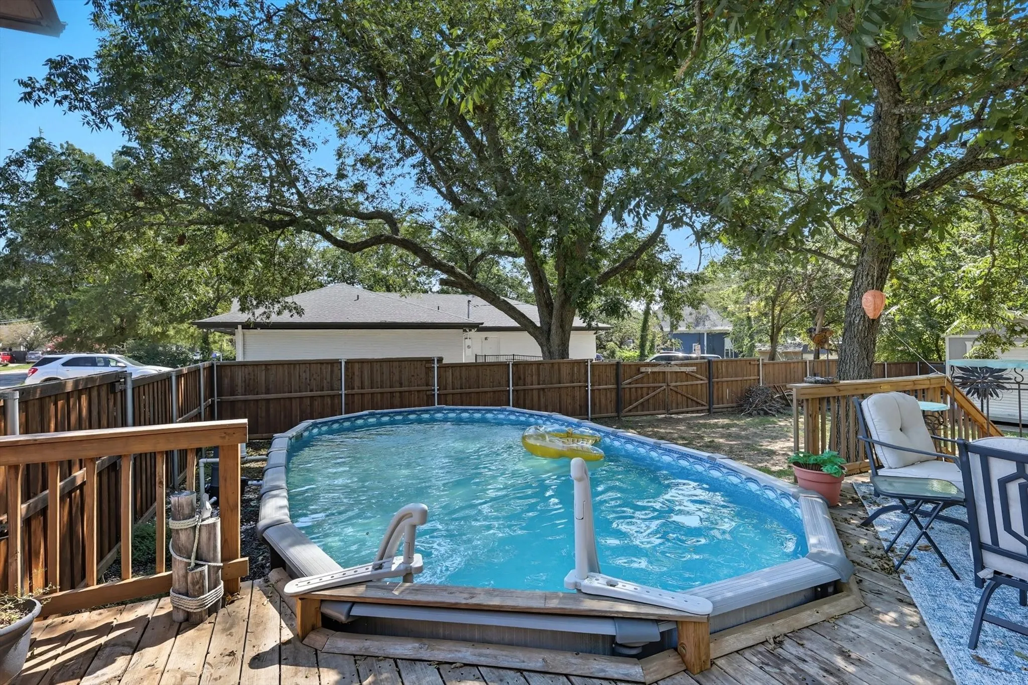 View of swimming pool with a deck and a fenced backyard