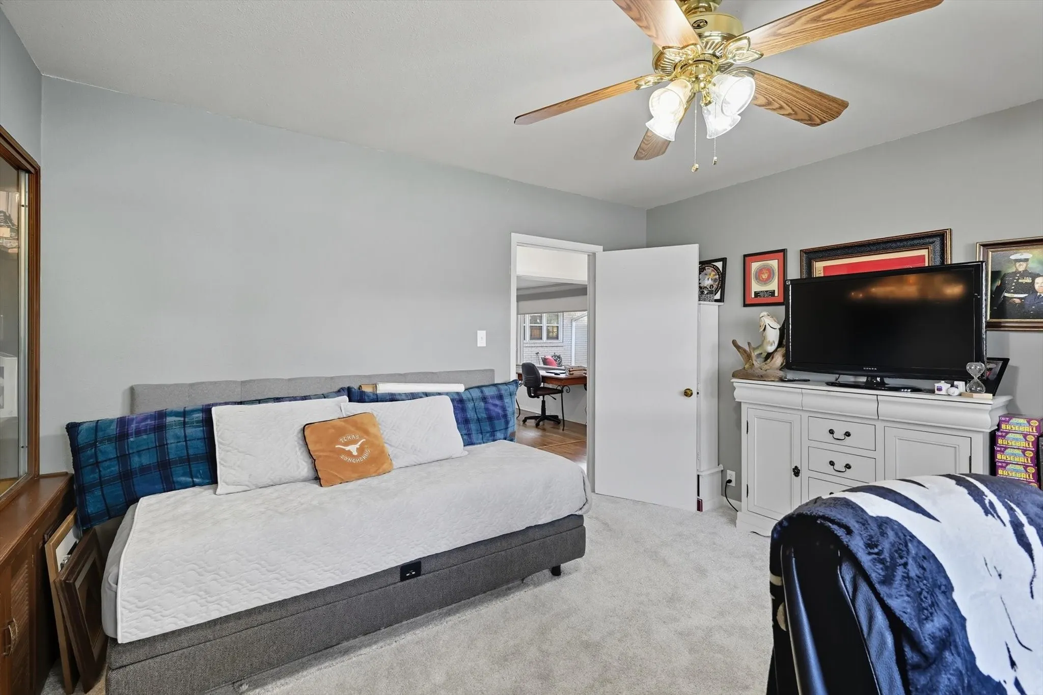 Bedroom featuring light carpet and a ceiling fan
