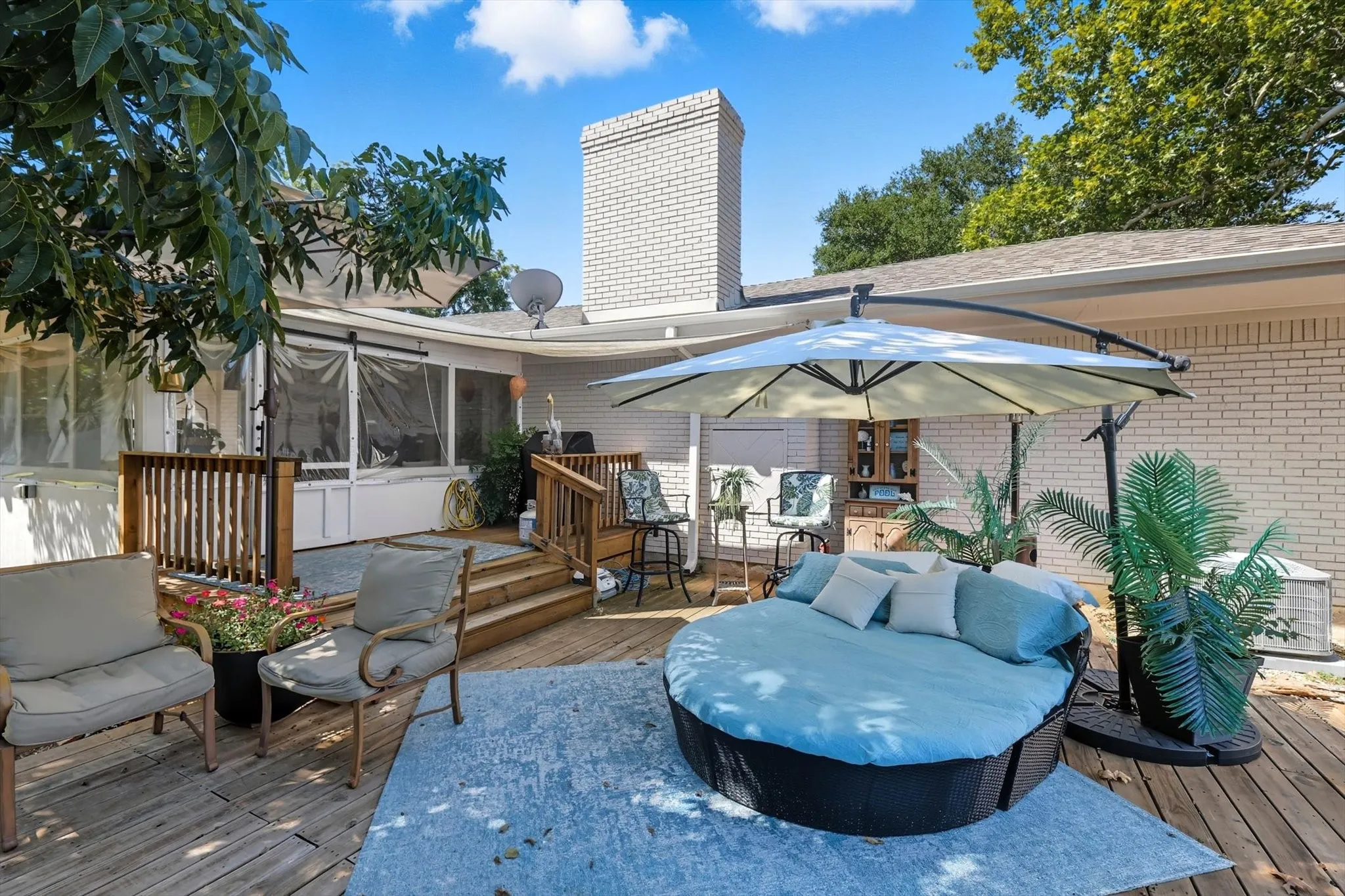 Deck with a sunroom and an outdoor living space