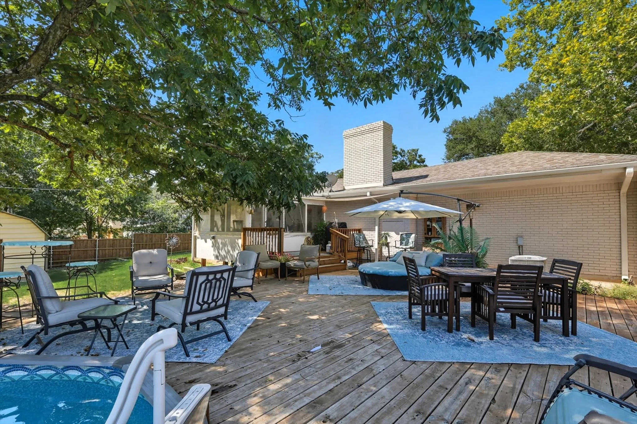 Wooden deck featuring outdoor dining space, outdoor lounge area, and a patio