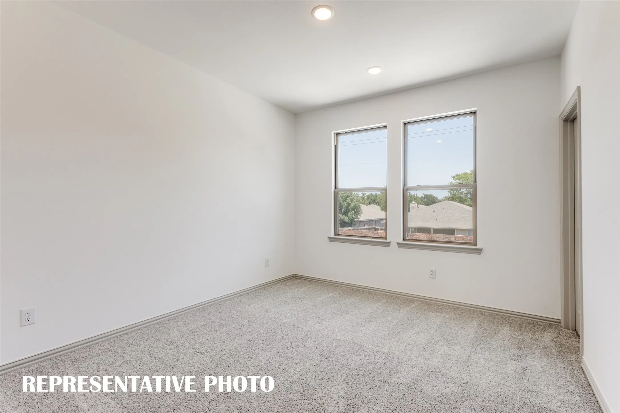 One of two spacious secondary bedrooms in our Tatum floor plan.  REPRESENTATIVE PHOTO.