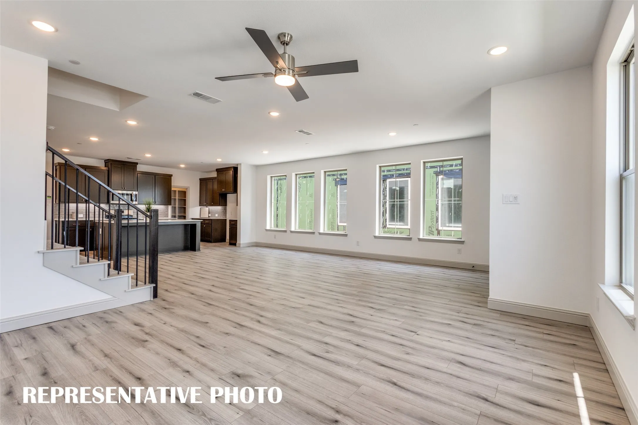 Featuring walls of windows throughout the main floor, this beautiful home is filled with natural light.  REPRESENTATIVE PHOTO.
