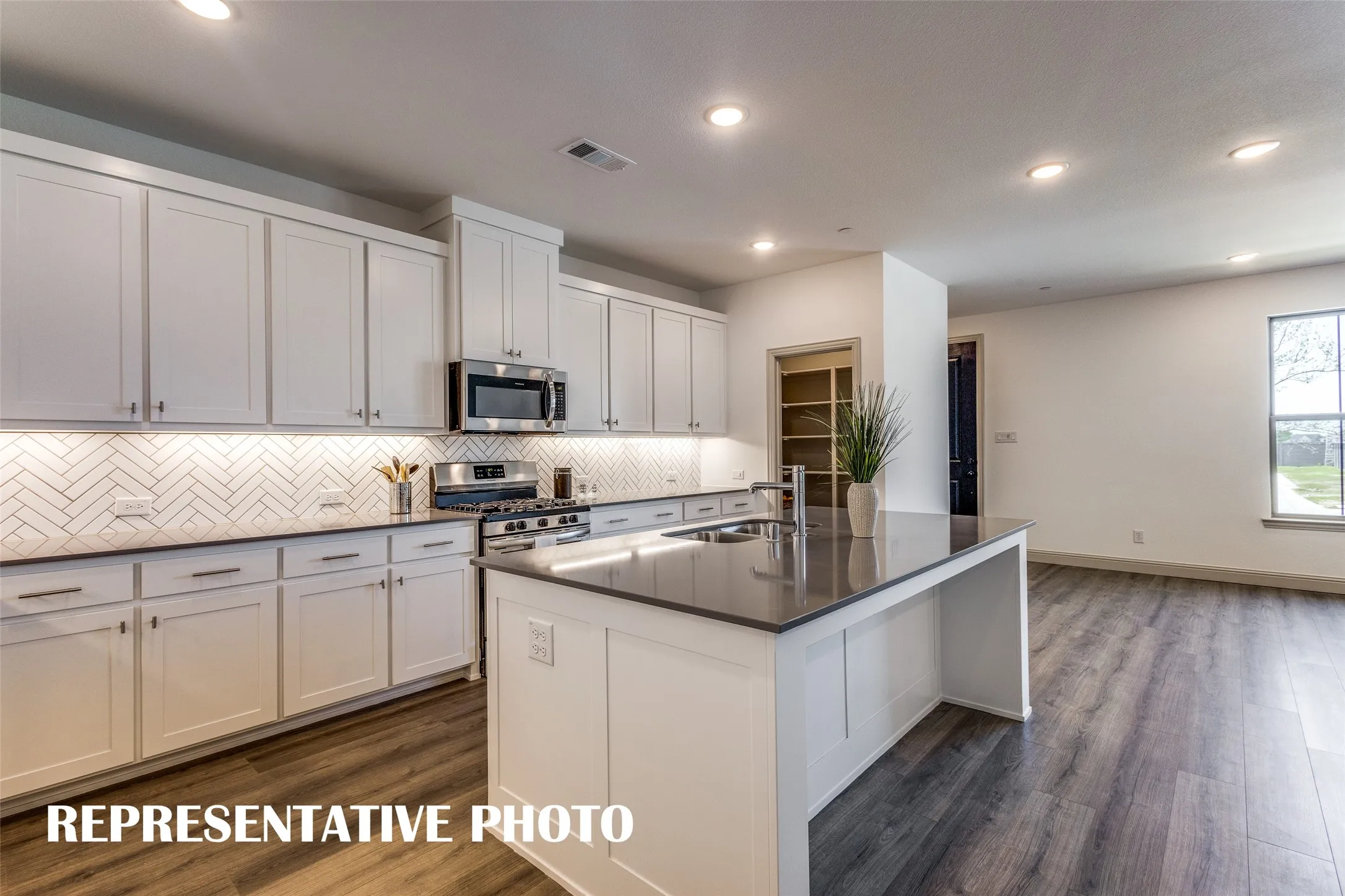 With ample storage and prep space, this kitchen offers everything you have been searching for in a dream kitchen!  REPRESENTATIVE PHOTO
