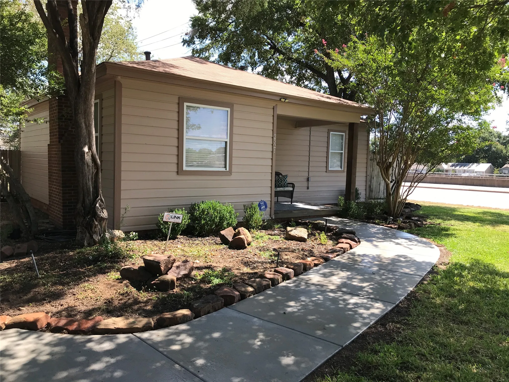 Tan siding exterior with a covered front porch