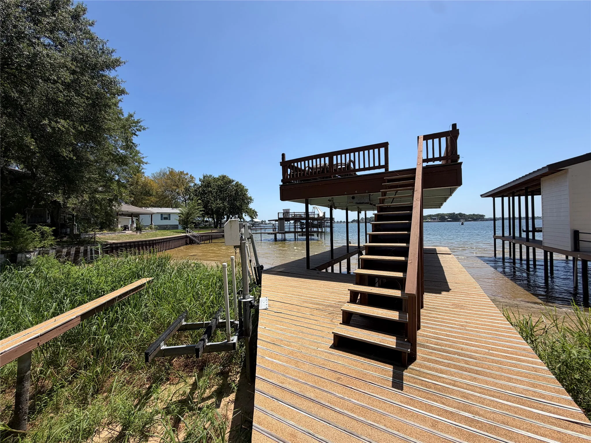 Dock with lower deck and an elevated sundeck with railings