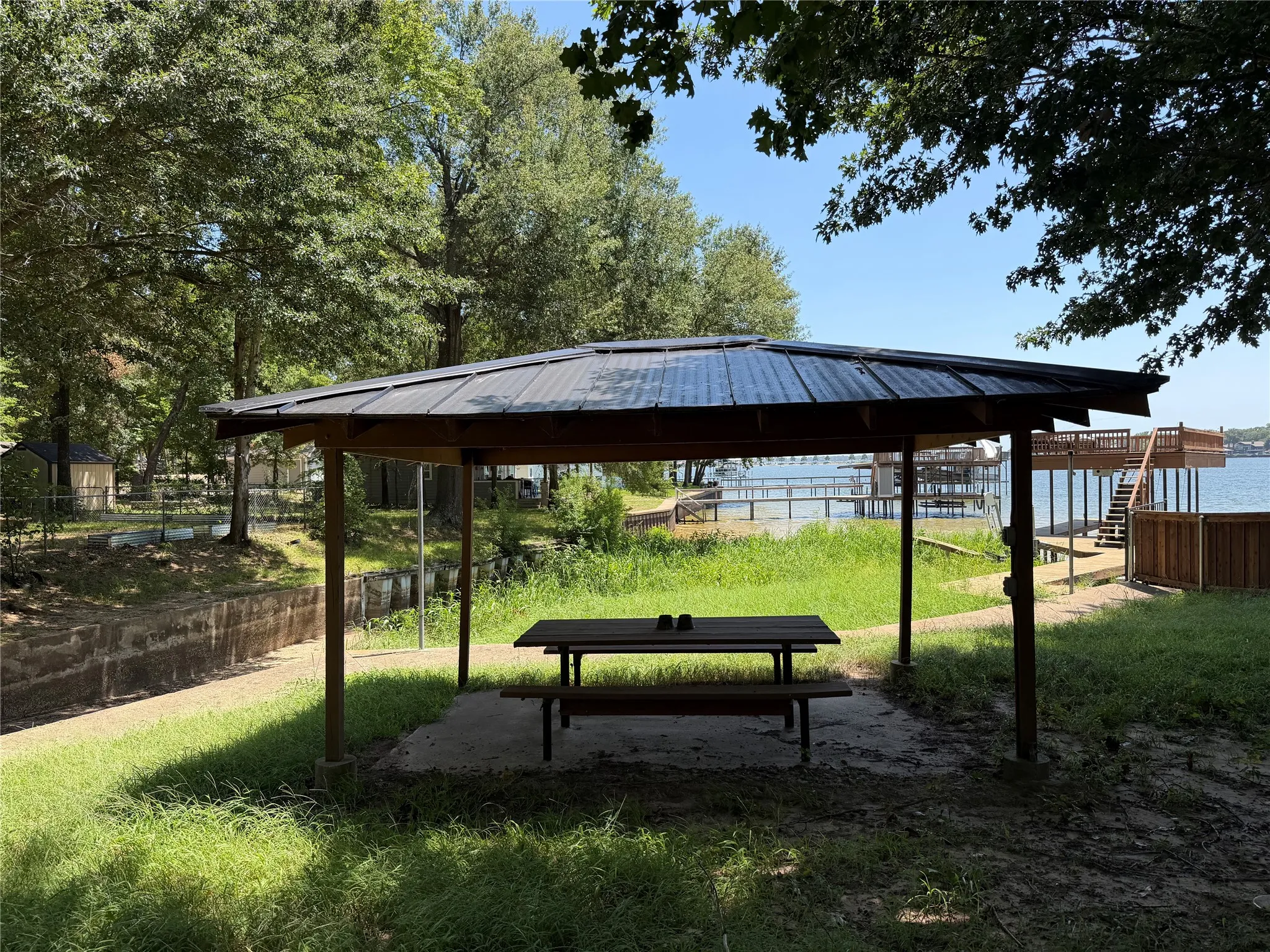 Waterfront gazebo with a metal roof and concrete pad