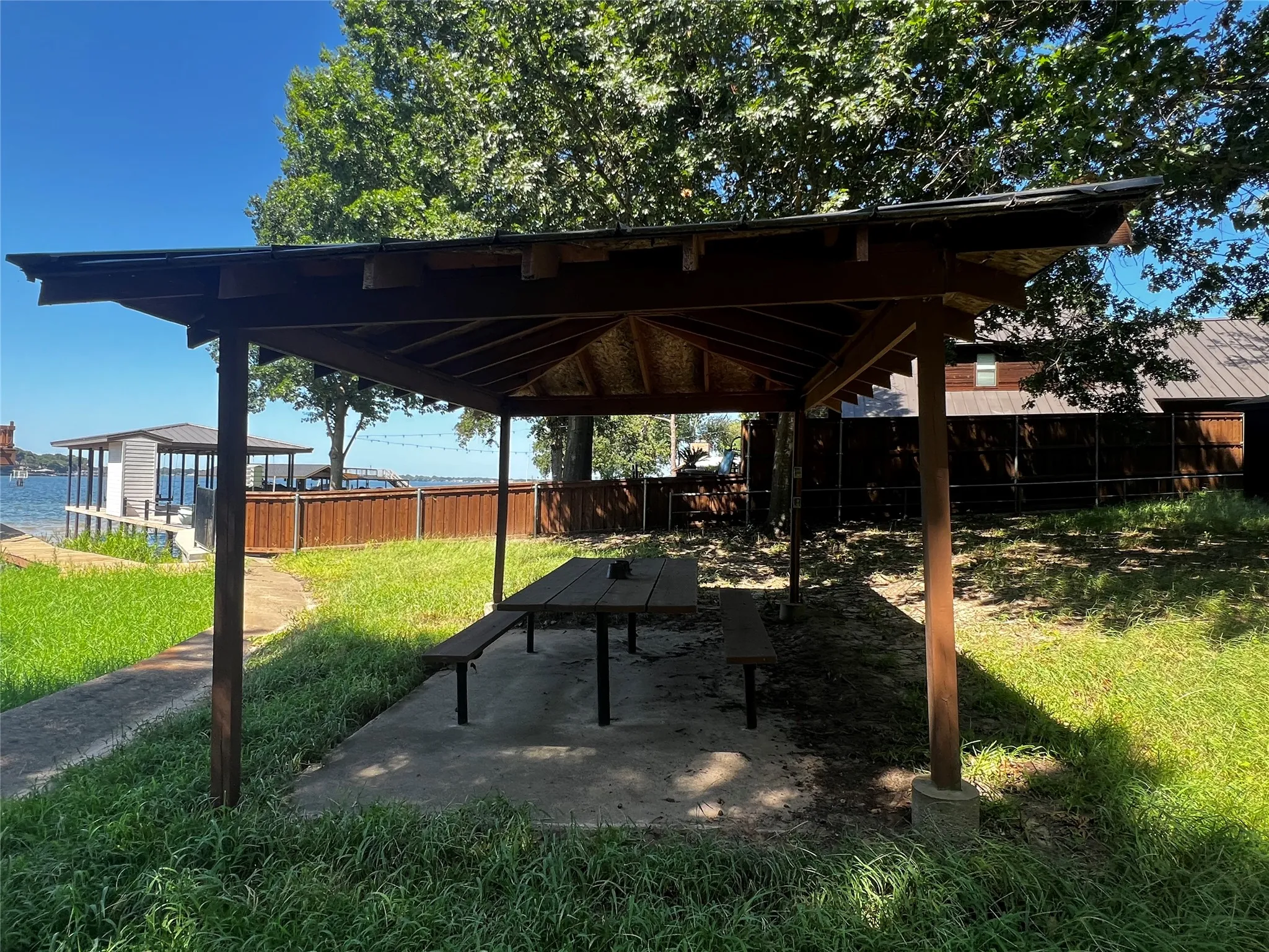 Patio at lakefront with the concrete walkway along retaining wall

