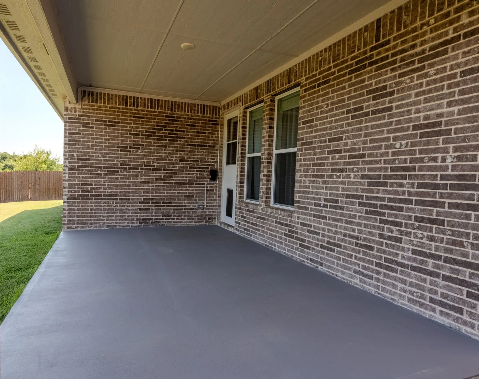 Expansive covered patio overlooks the backyard and provides excellent shade and usable outdoor space.