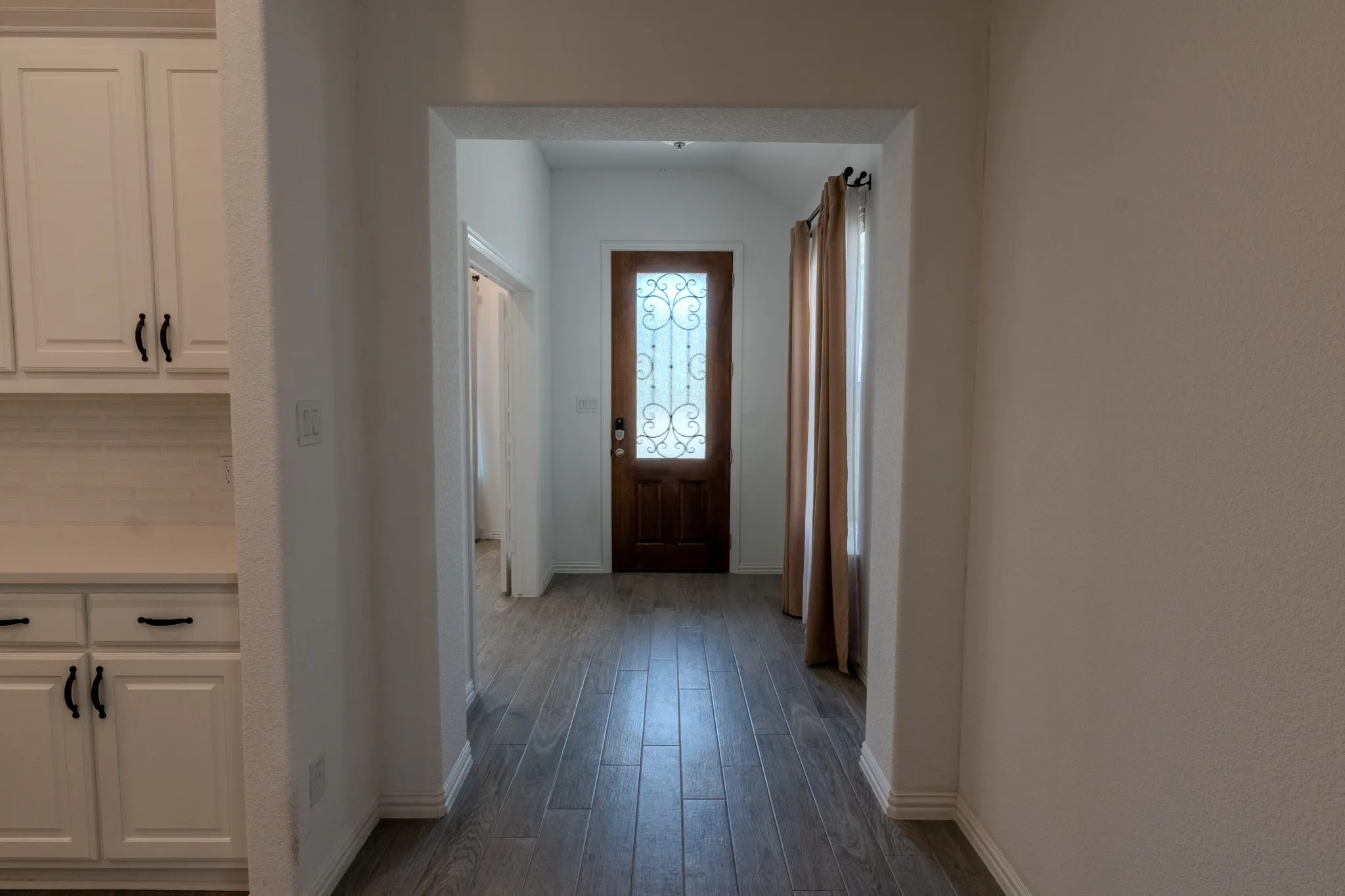 Welcoming entryway opens into the home with a bright, clean, neutral interior.