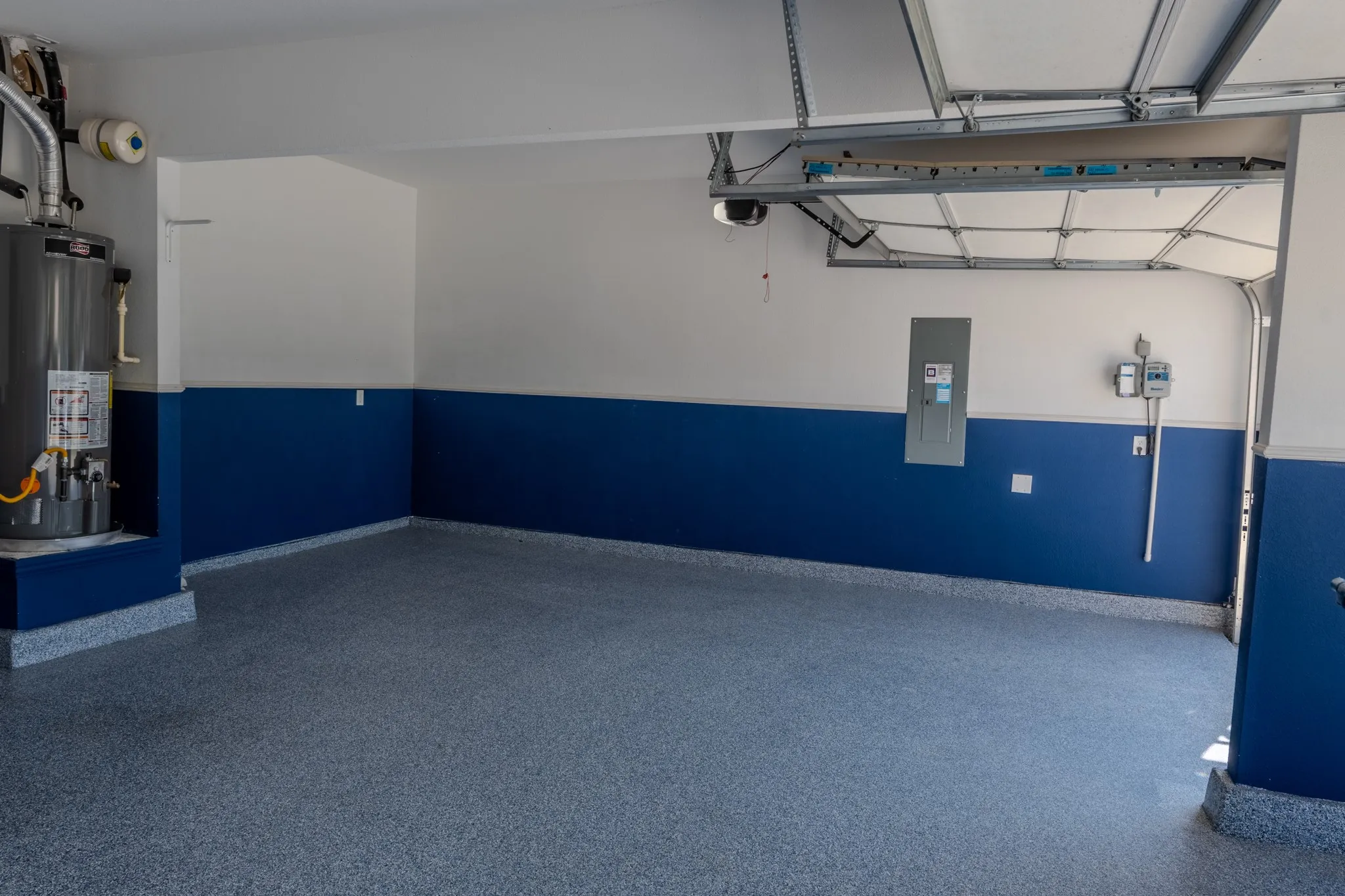 Another view of the impressive garage, complete with epoxy floors and a Tesla EV charger for convenient at-home charging.