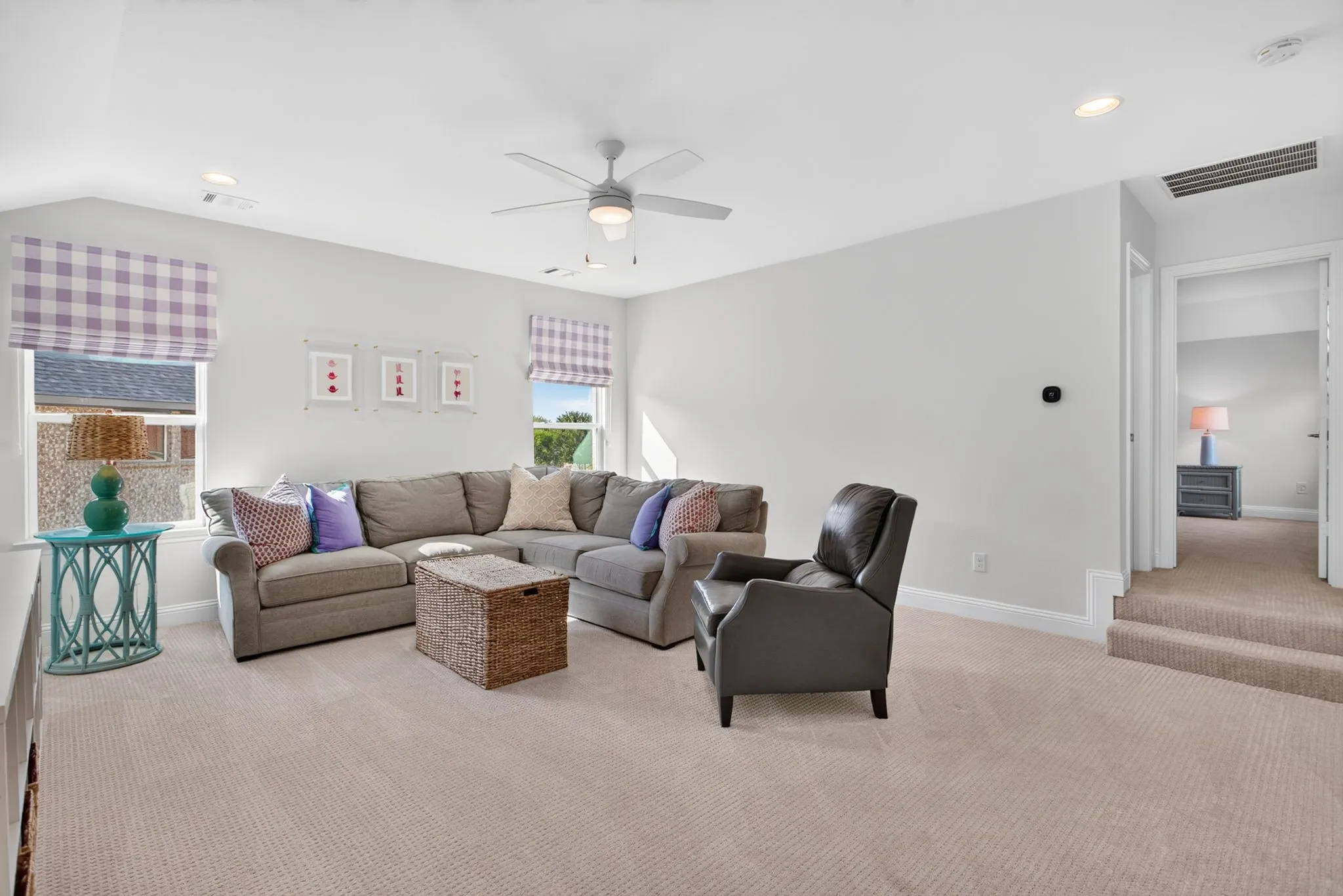 Large upstairs family room with upgraded carpet and pad, and custom shades.