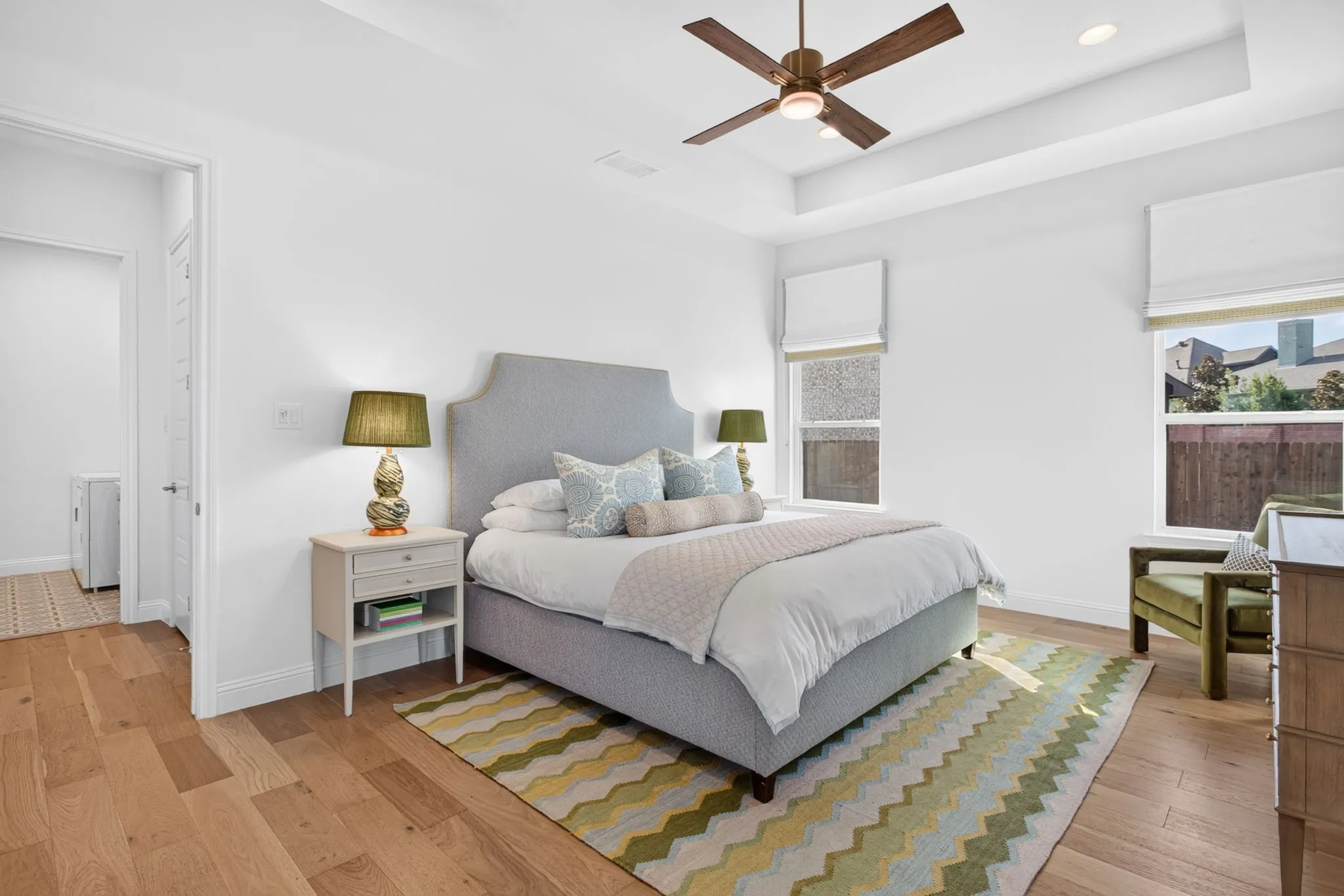 Primary ensuite is spacious with upgraded ceiling fan, custom drapes and eng. hardwood floors.