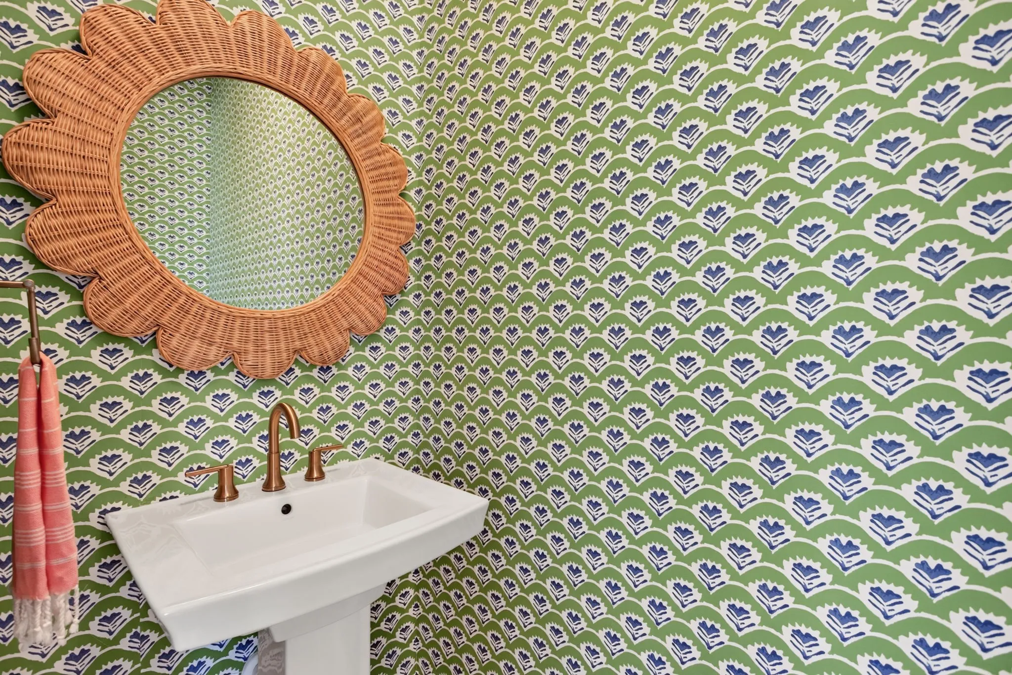 First floor powder room with custom professionally installed wallpaper and deco mirror.