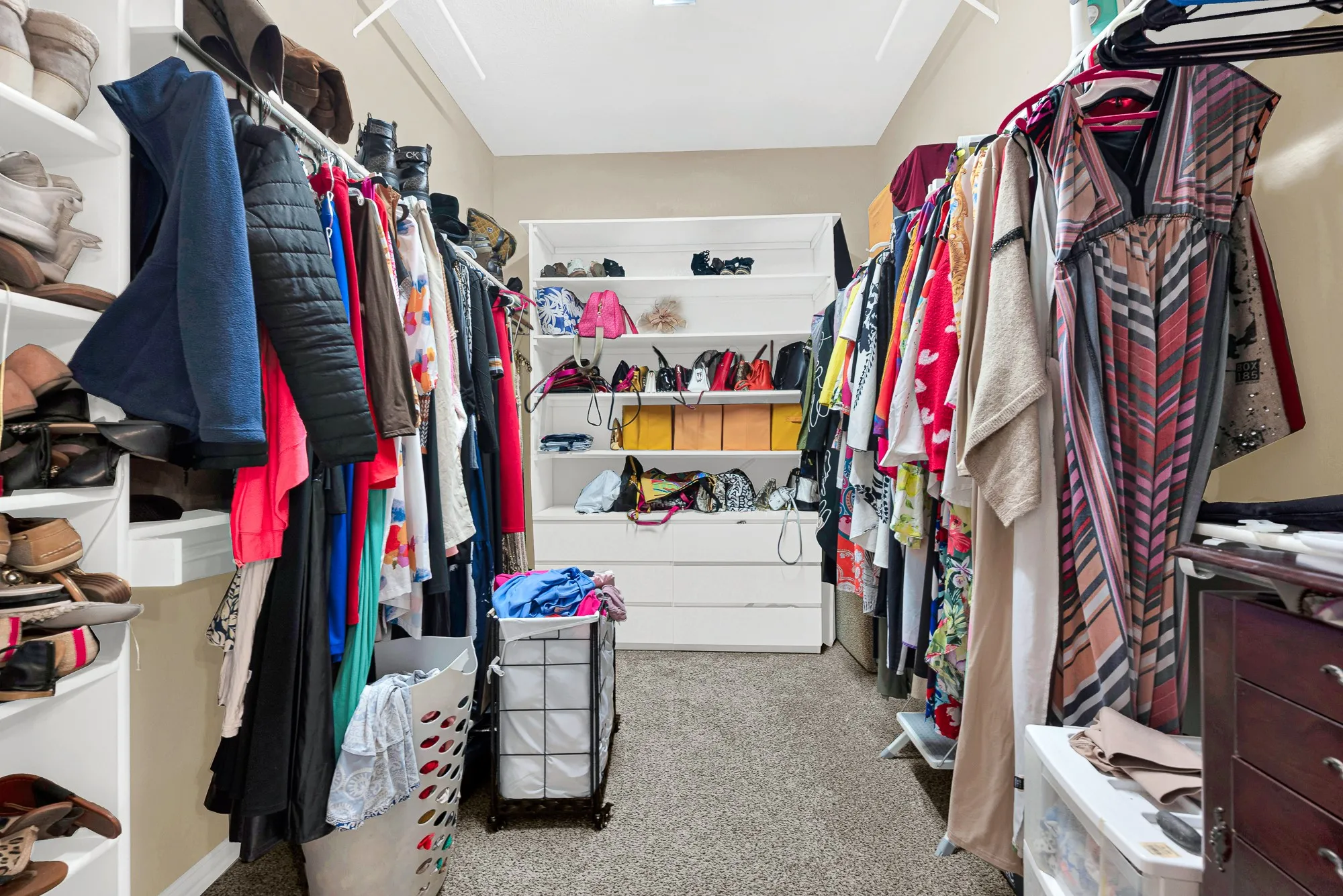 Built-in shelving, hanging rods, and integrated drawers provide ample storage
