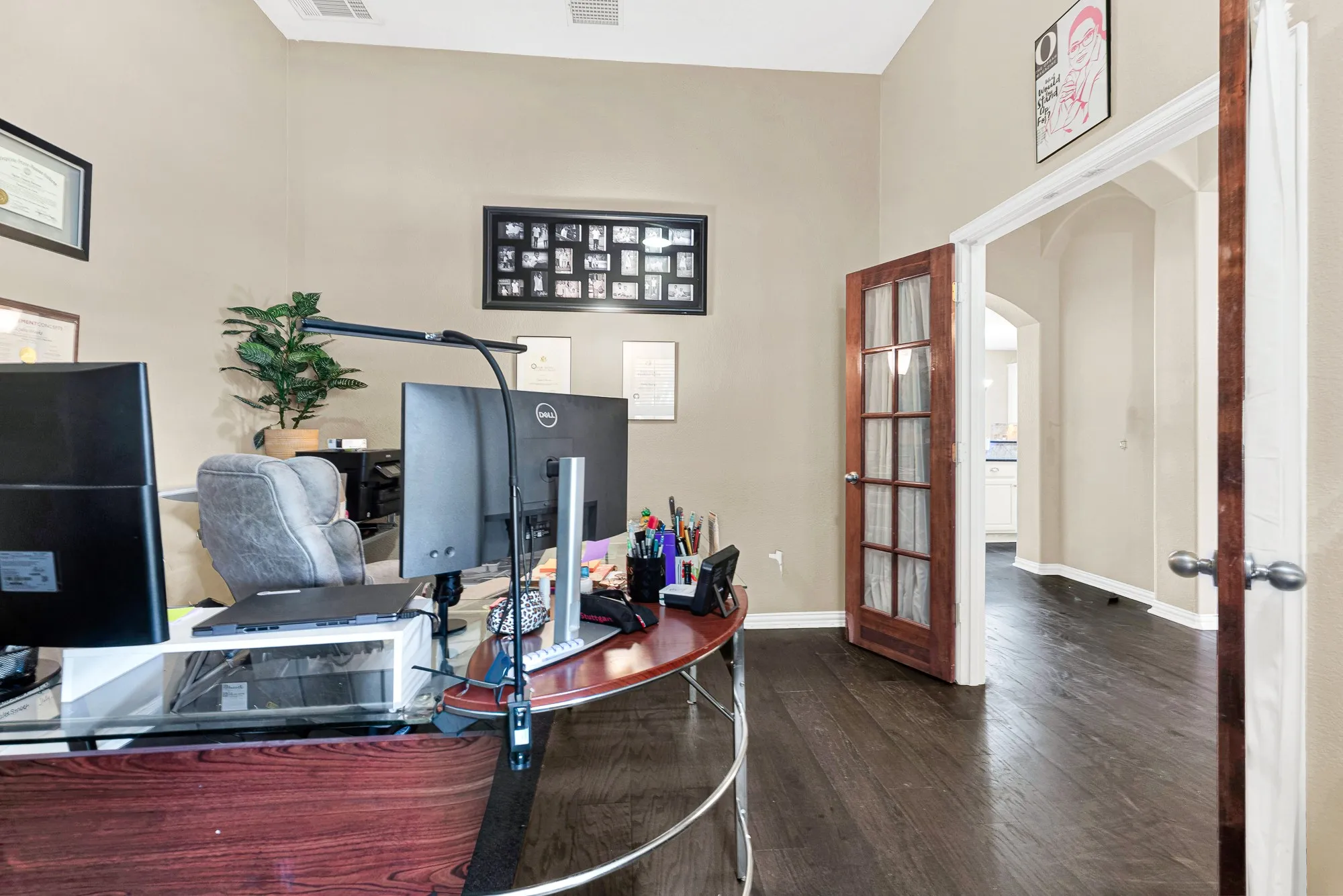 Wood-finish flooring, neutral wall paint, and a wood-frame French door with glass panels