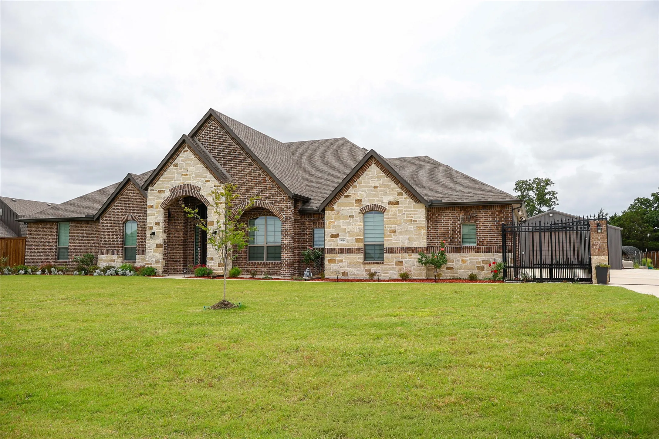 Brick and stone veneer exterior with arched entry
