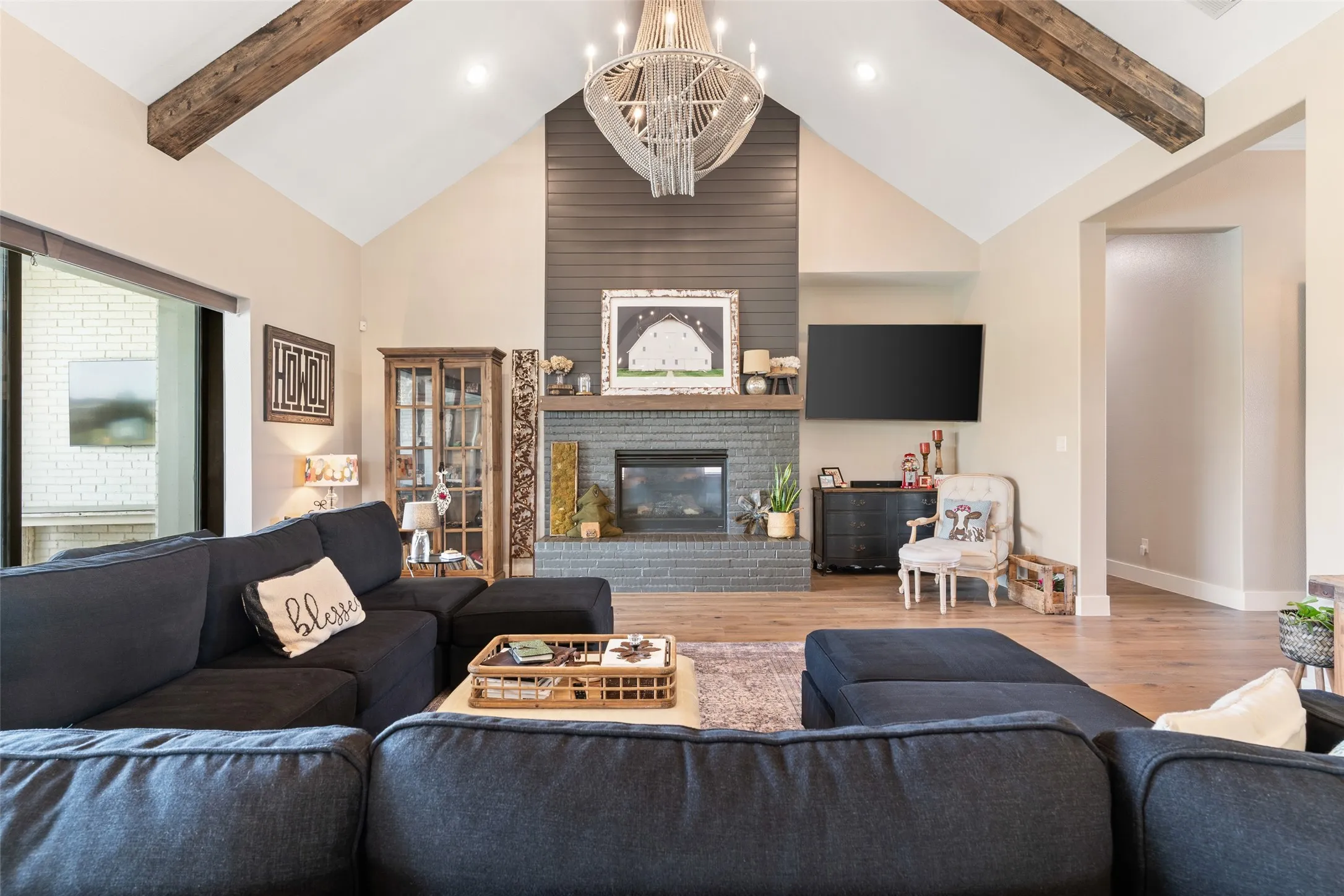 Anchoring the grand living space beneath the soaring cathedral ceilings is a stunning floor-to-ceiling fireplace.
