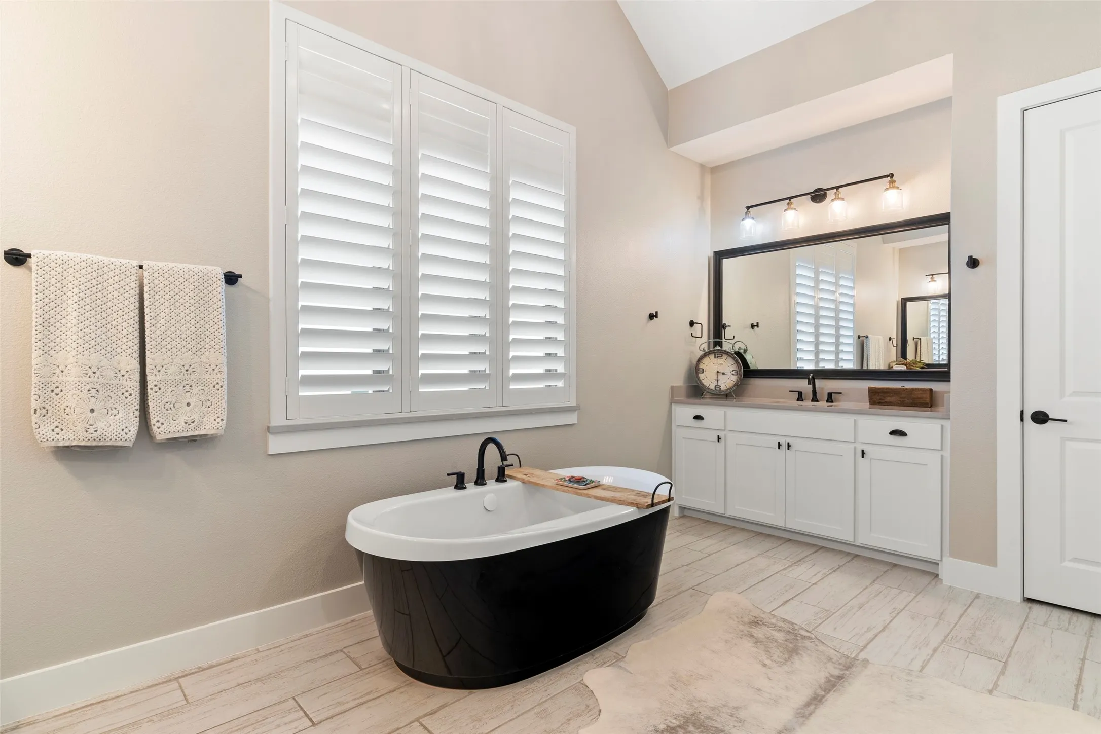 Sleek custom tub for a relaxing soak.  His and hers closets.