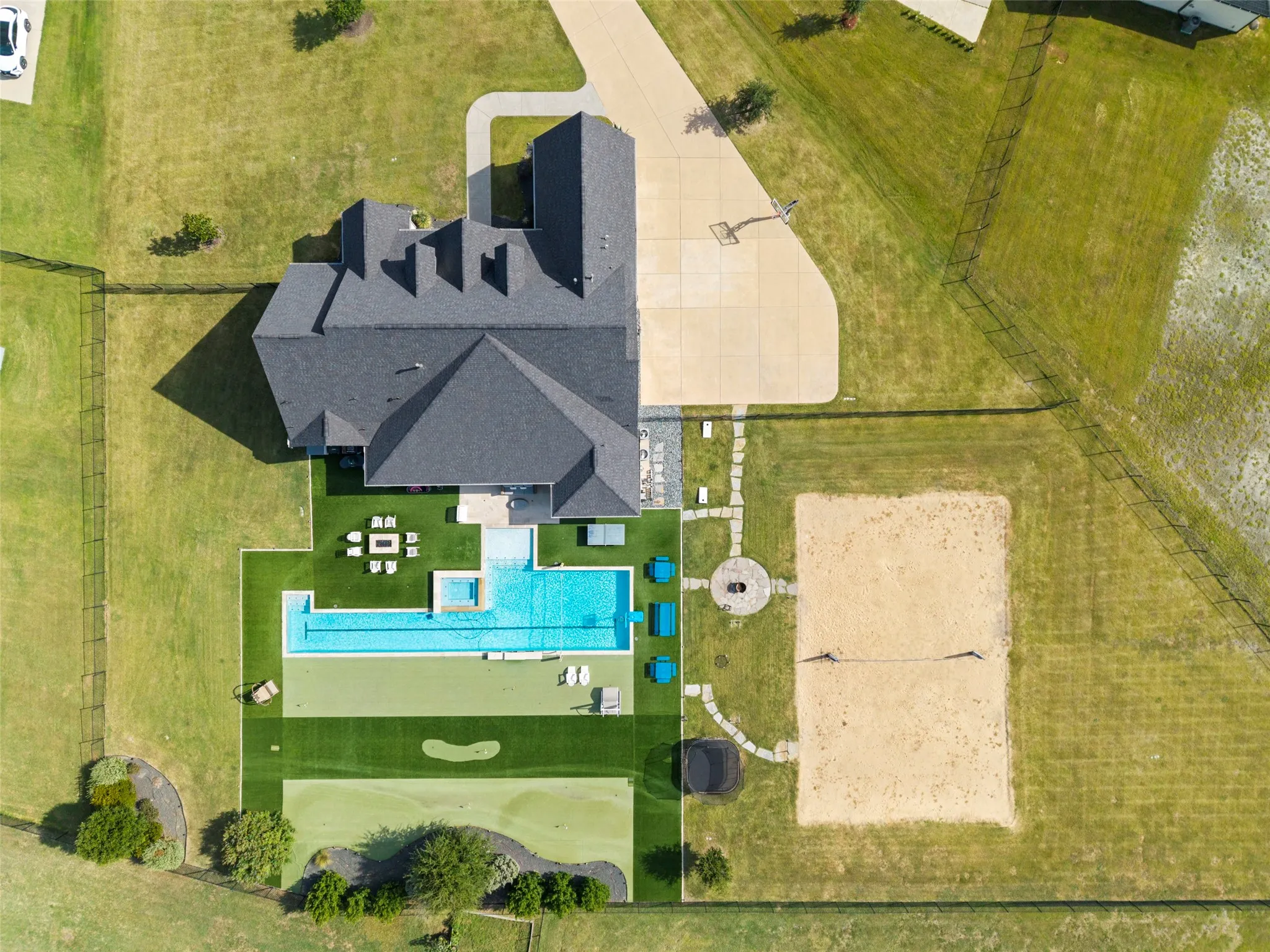 YOU CAN HAVE IT ALL!!  Overflow parking, basketball, fire pit, sand volleyball, golf, lap pool, sports pool, hot tub and indoor/outdoor living all on approximately 1.43 acre.